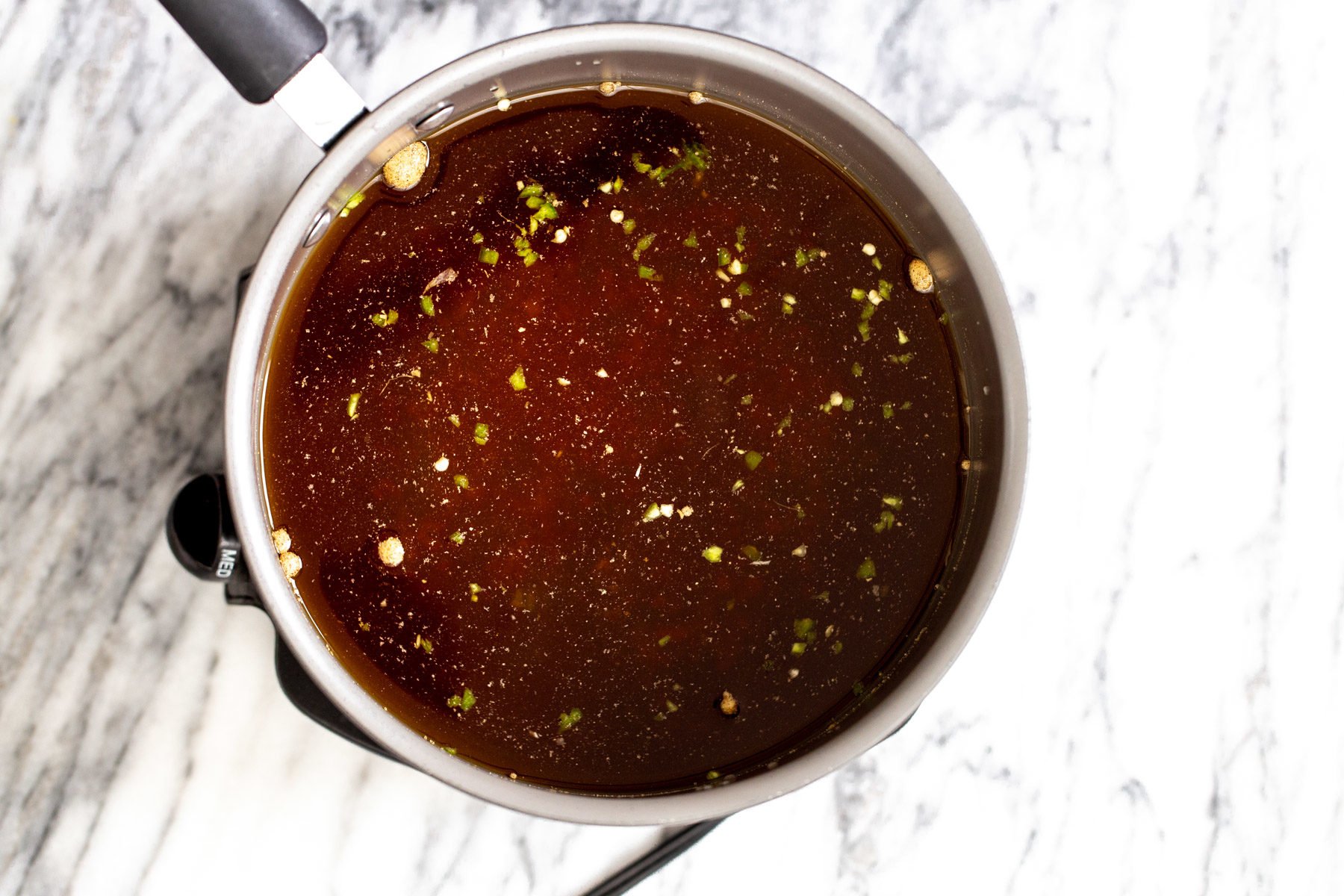 a pot with hot and sour soup broth
