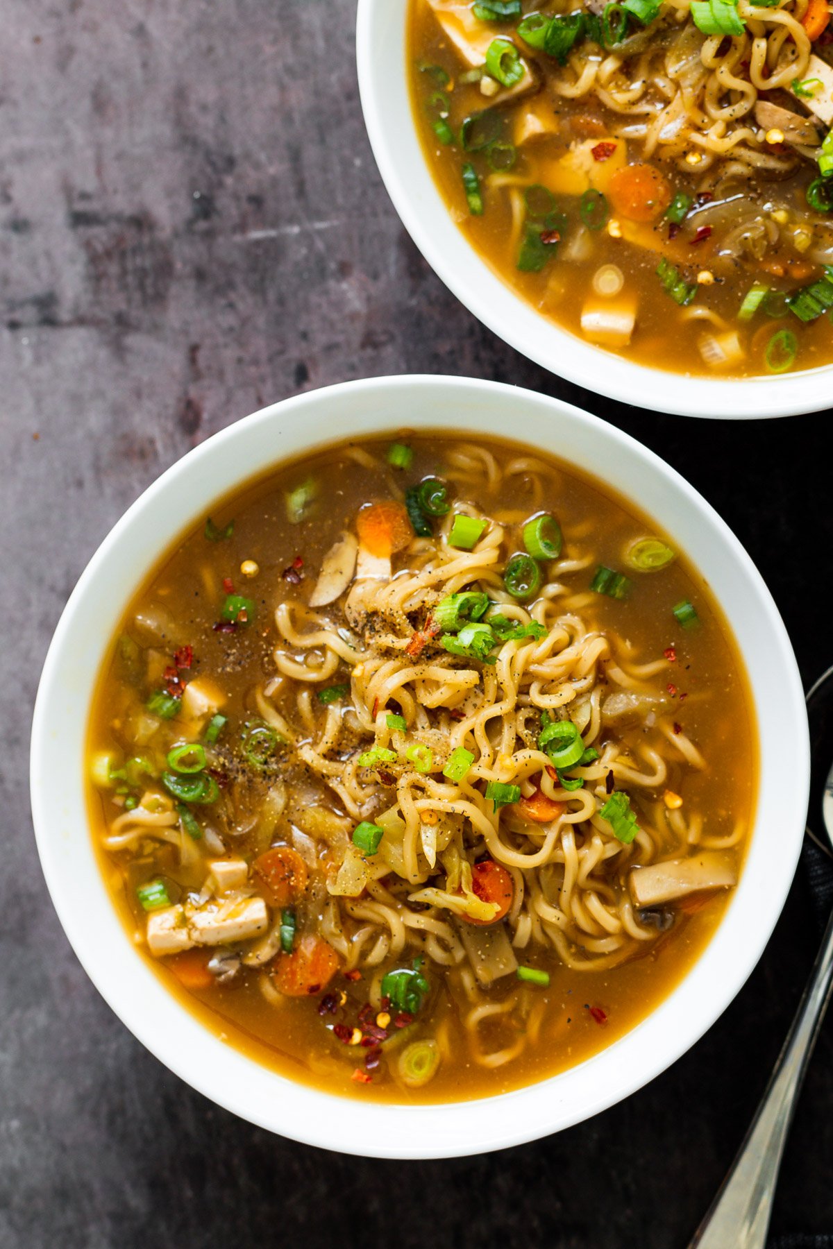 vegan hot and sour soup overhead shot of two bowl of Chinese Hot and Sour Soup with Ramen noodles served in two soup bowls