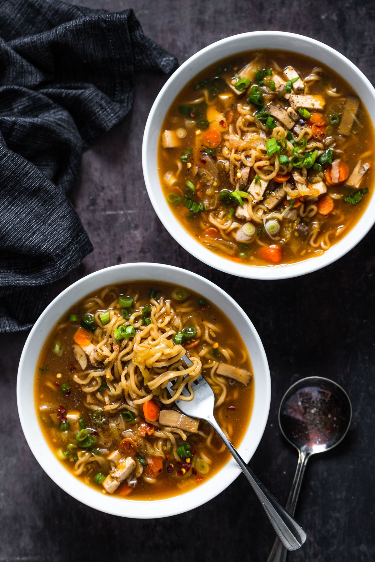 overhead shot of two bowl of Chinese Hot and Sour Soup with Ramen noodles served in two soup bowls
