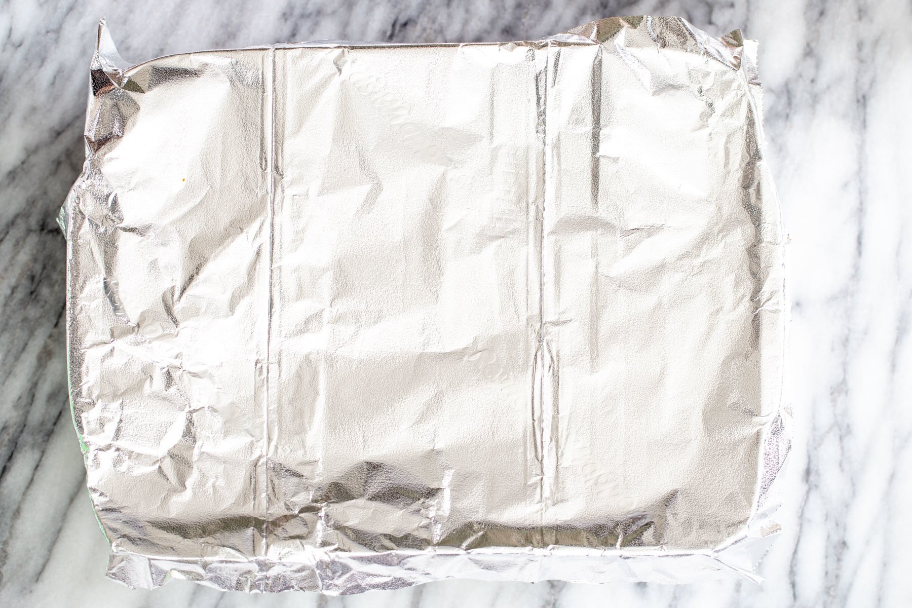 vegan stuffed shells a casserole dish covered with aluminum foil