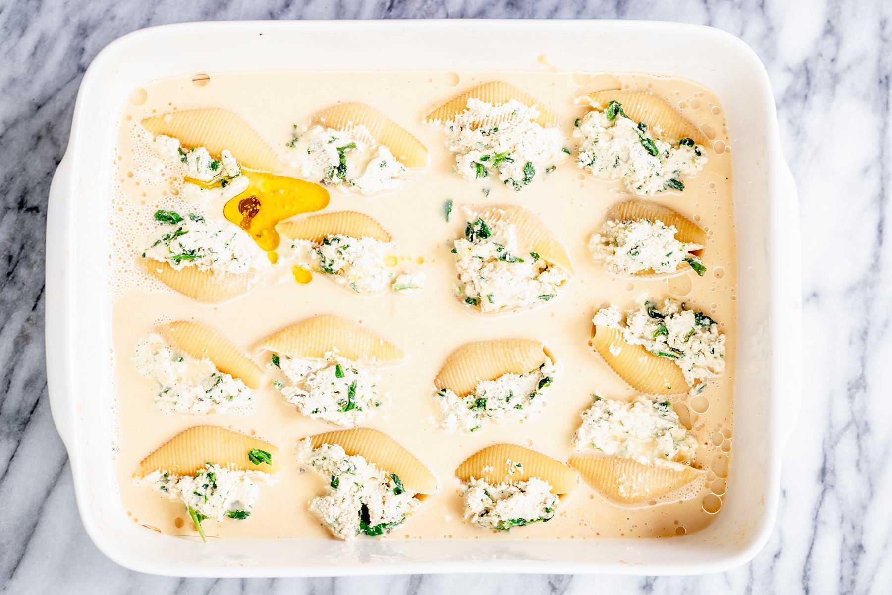 vegan stuffed shells overhead shot of casserole dish with vegan stuffed shells before baking