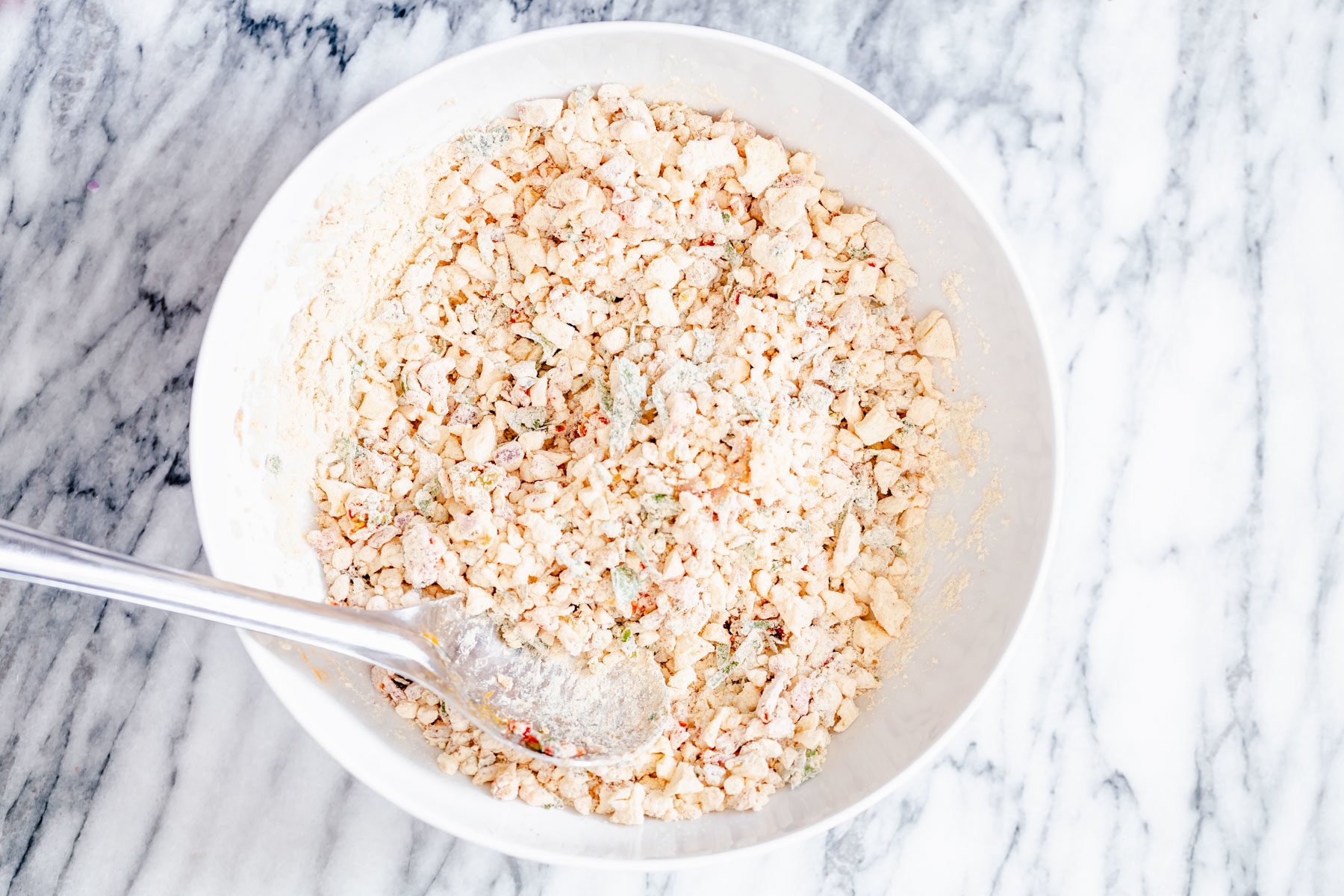 chickpea flour waffle batter being mixed in a white bowl