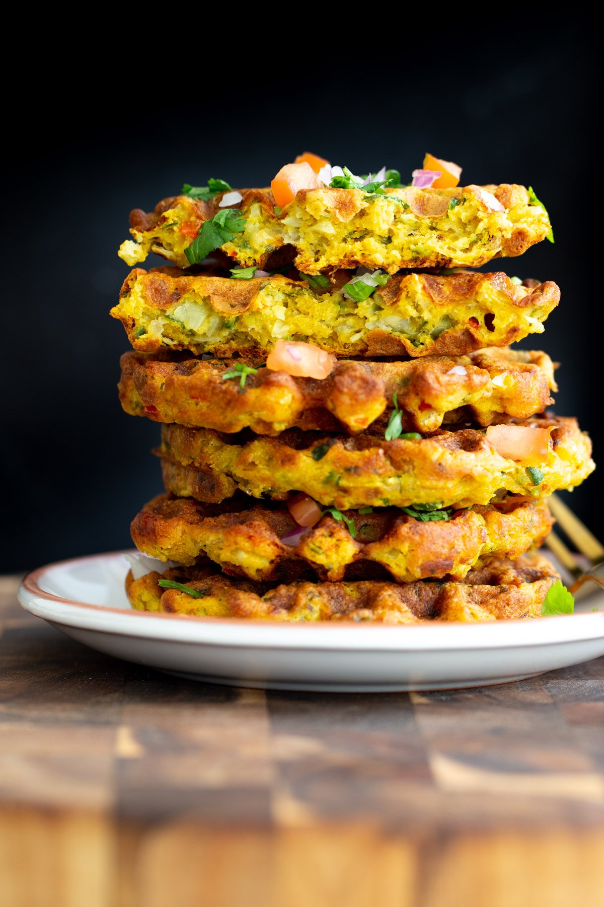 stacked vegan chickpea flour waffles against a black background
