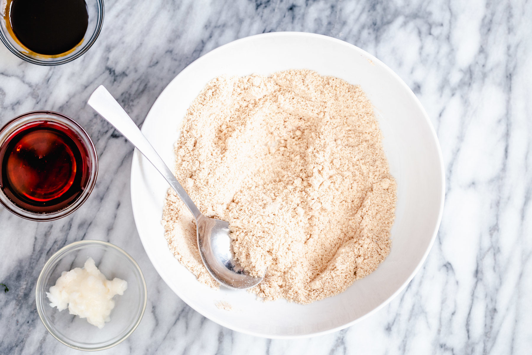 vegan gingerbread cookies  vegan gingerbread cookie batter mix in a small white bowl