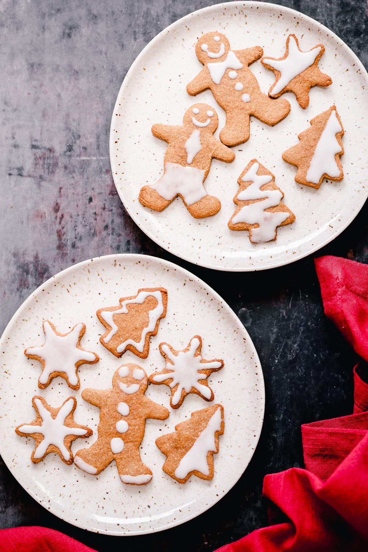 vegan gingerbread cookies two plates with vegan iced gingerbread cookies