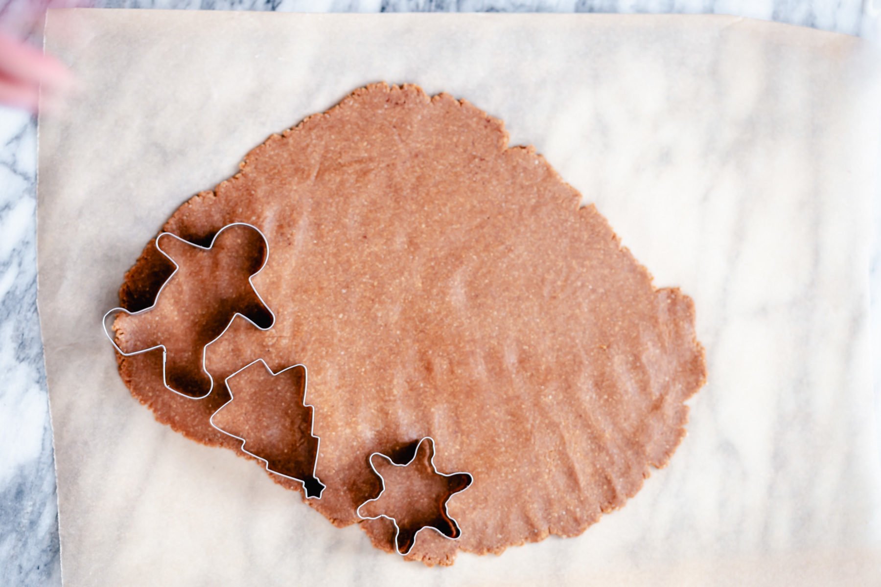vegan gingerbread cookies vegan gingerbread cookies being cut out