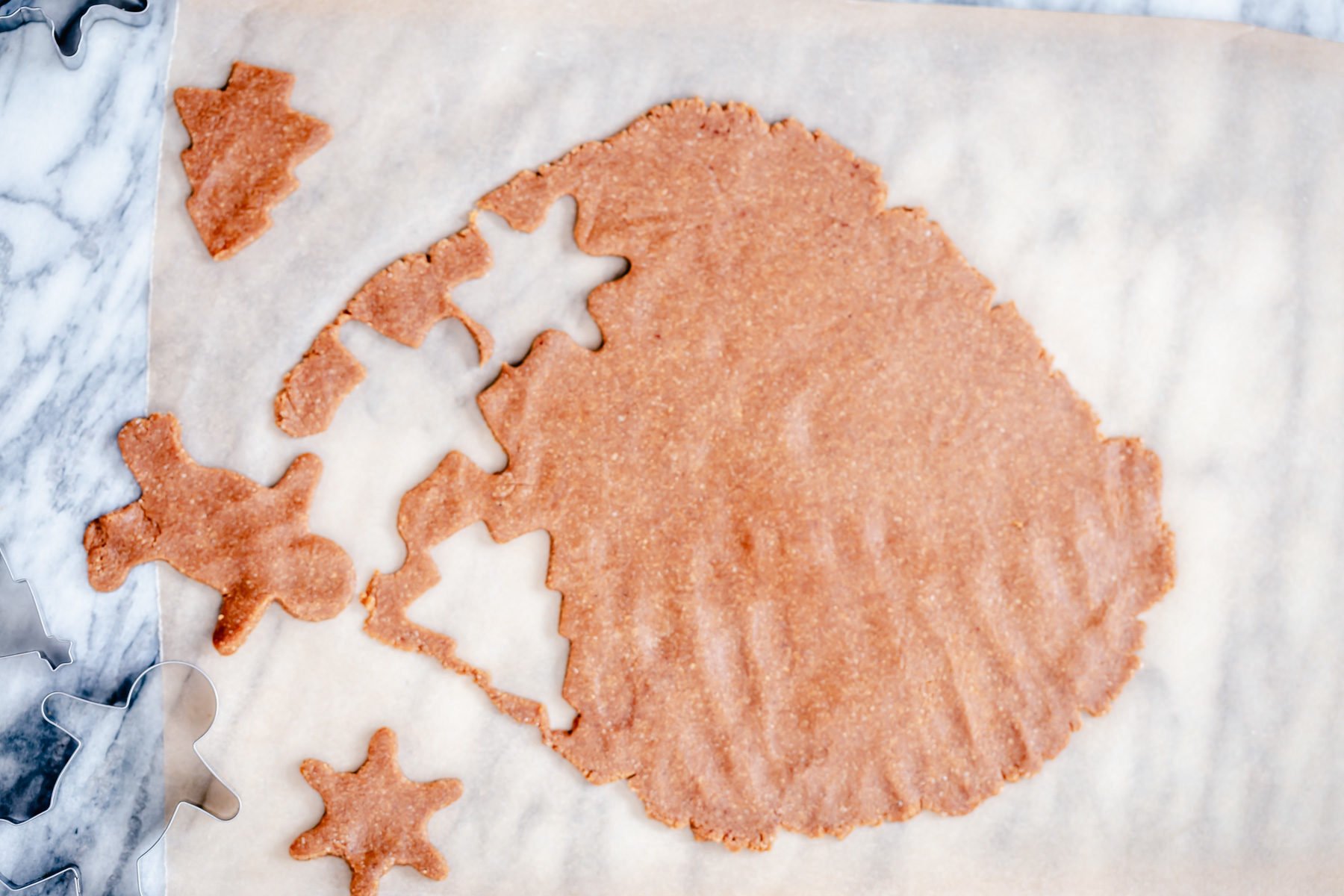 vegan gingerbread men  glutenfree cookie dough being but out using a star shaped and a gingerbread cookie cutter