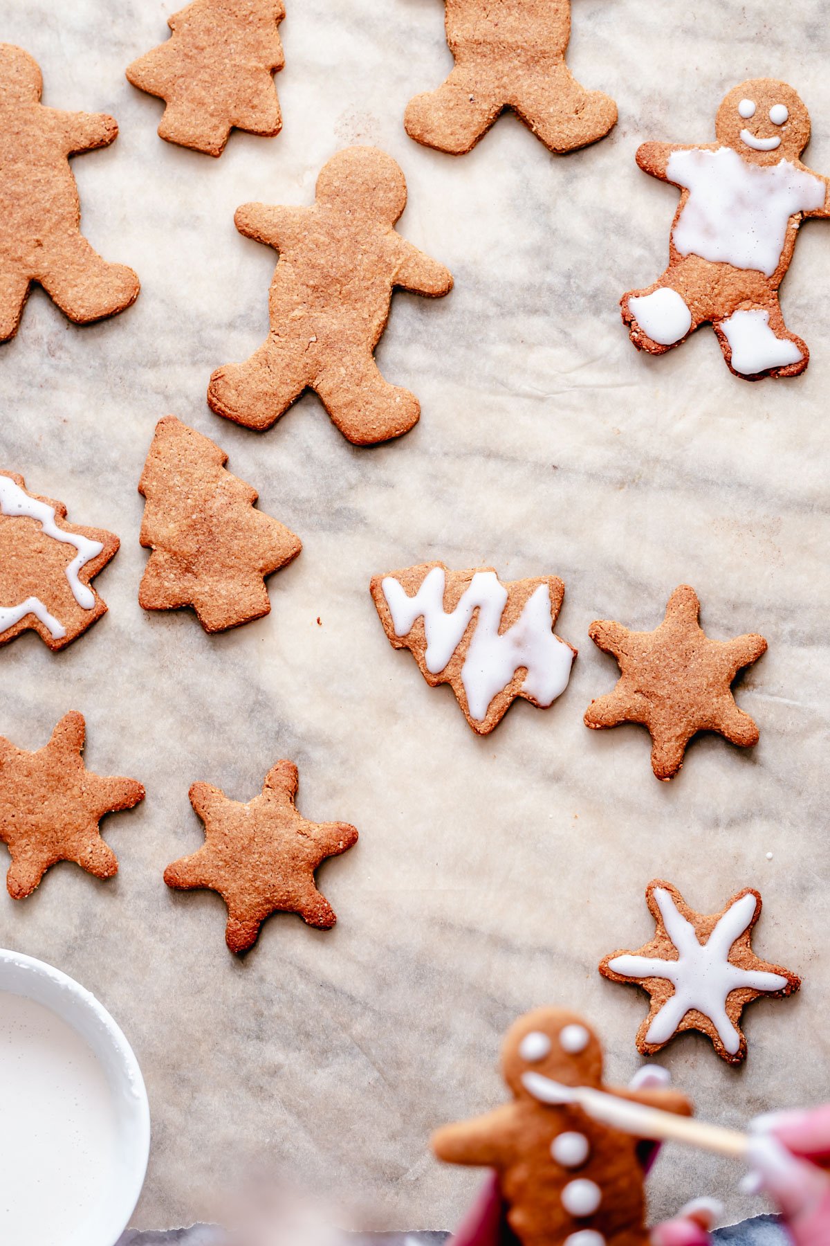 vegan gingerbread cookies iced vegan spiced gingerbread cookies on a marble countertop