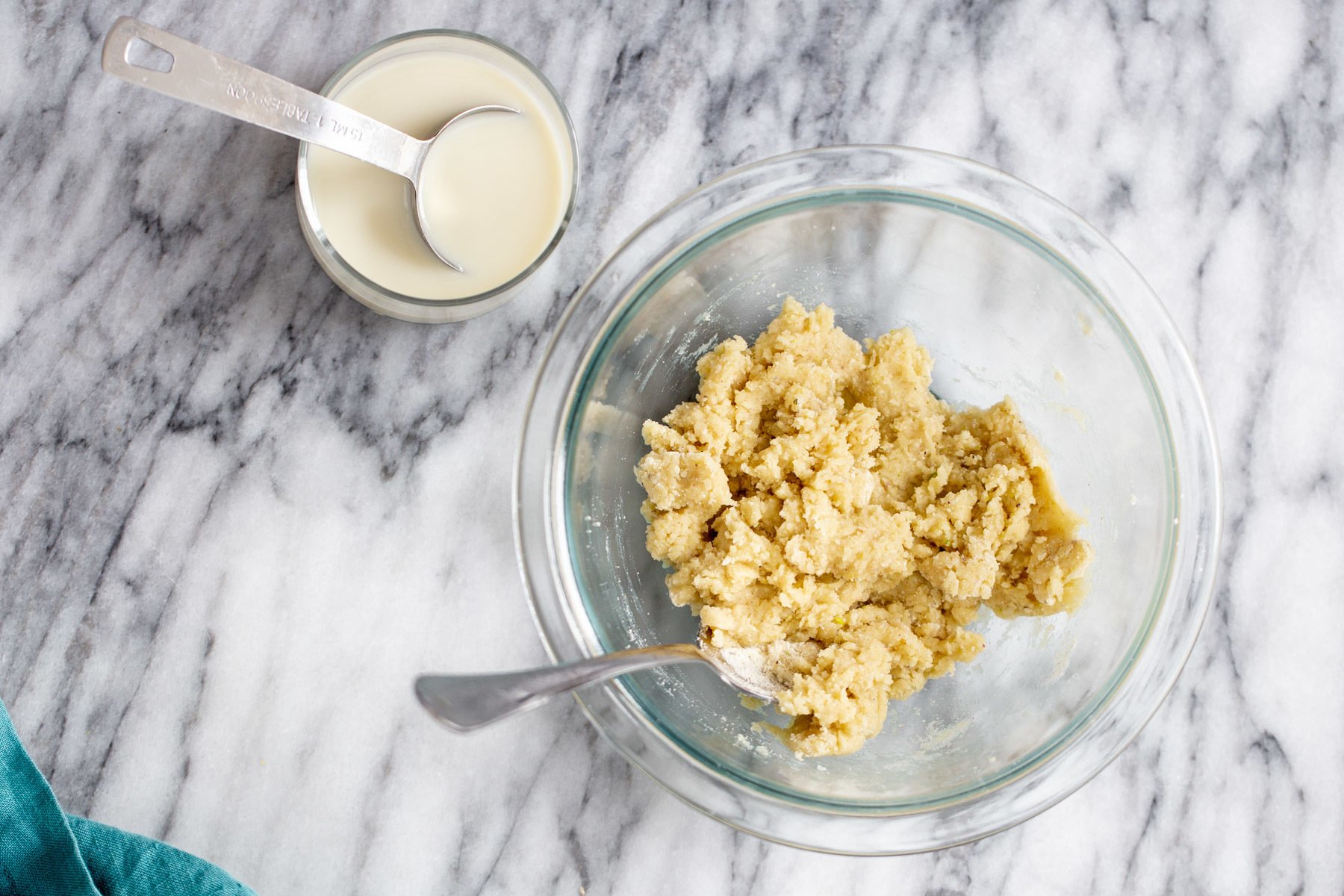 milk being added to donut batter for making vegan gulab jamun recipe