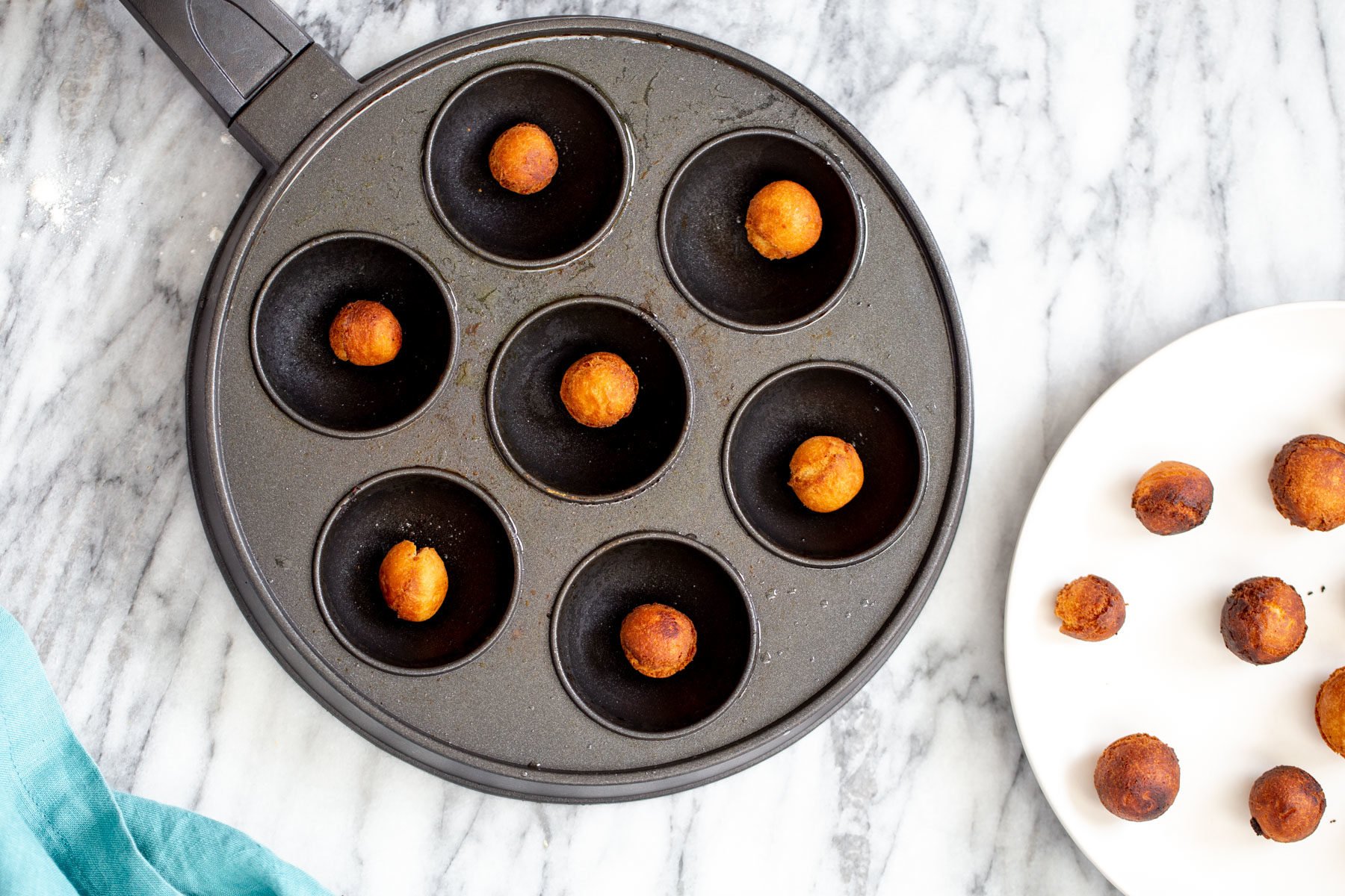 an aebleskiver pan with homemade vegan gulab jamun 