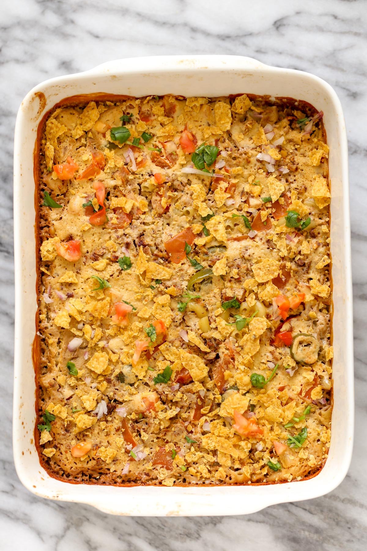 mac and cheese taco bake a casserole dish with vegan mac and cheese bake topped with crushed tortilla chips
