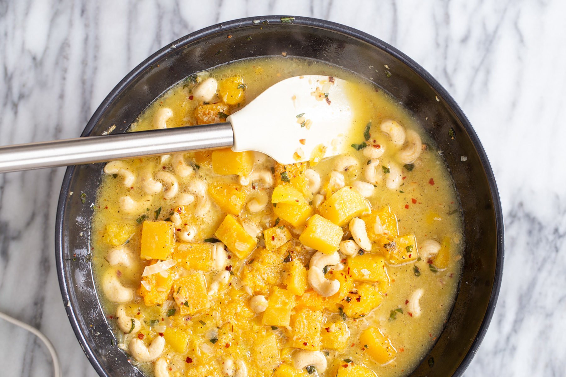 butternut alfredo for vegan stuffed shells in black skillet