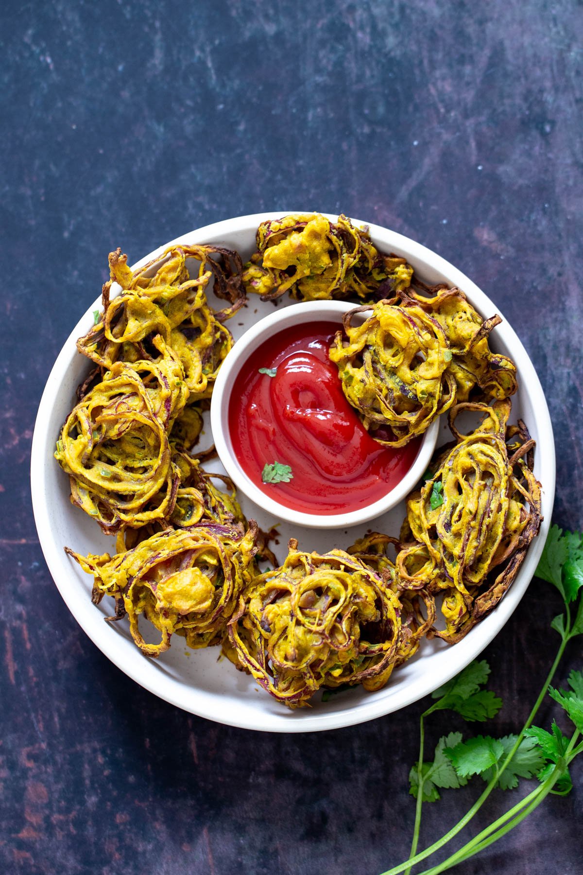 baked pakora overhead shot of baked onion pakora served with ketchup as a dipping sauce