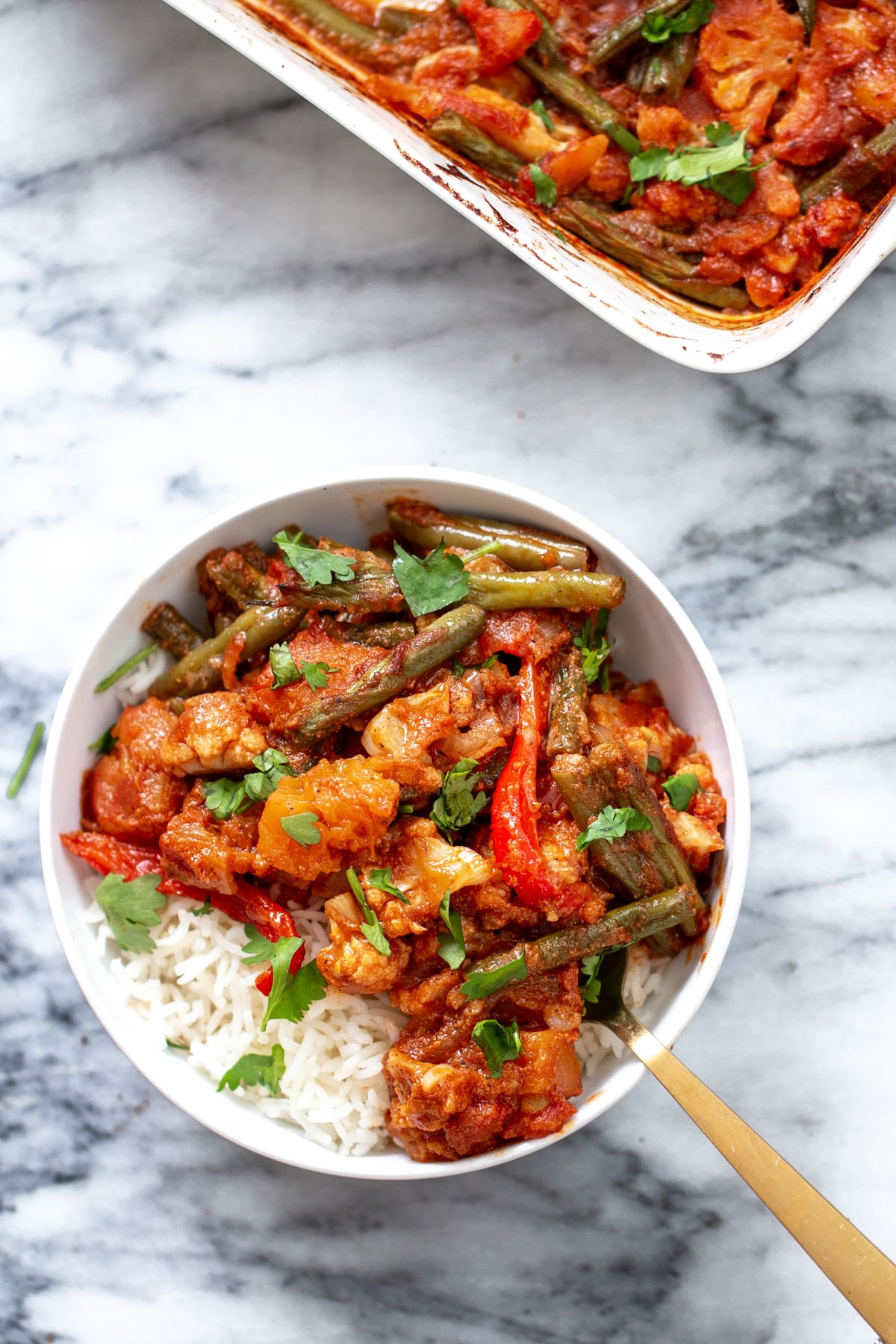 vegan vegetable casserole vegan vegetable casserole served in a bowl with rice and sprinkled with cilantro