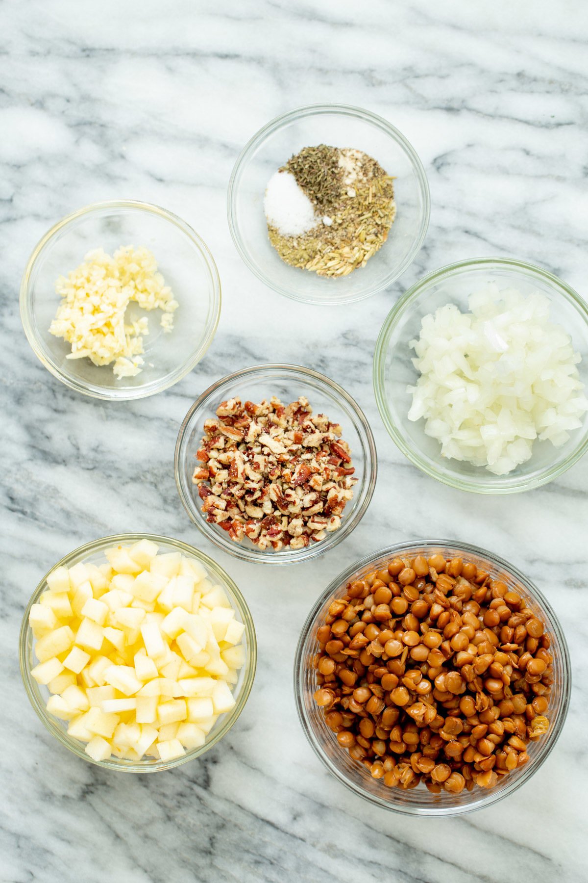 vegan stuffed butternut squash ingredients for making vegan stuffed butternut squash on a marble countertop