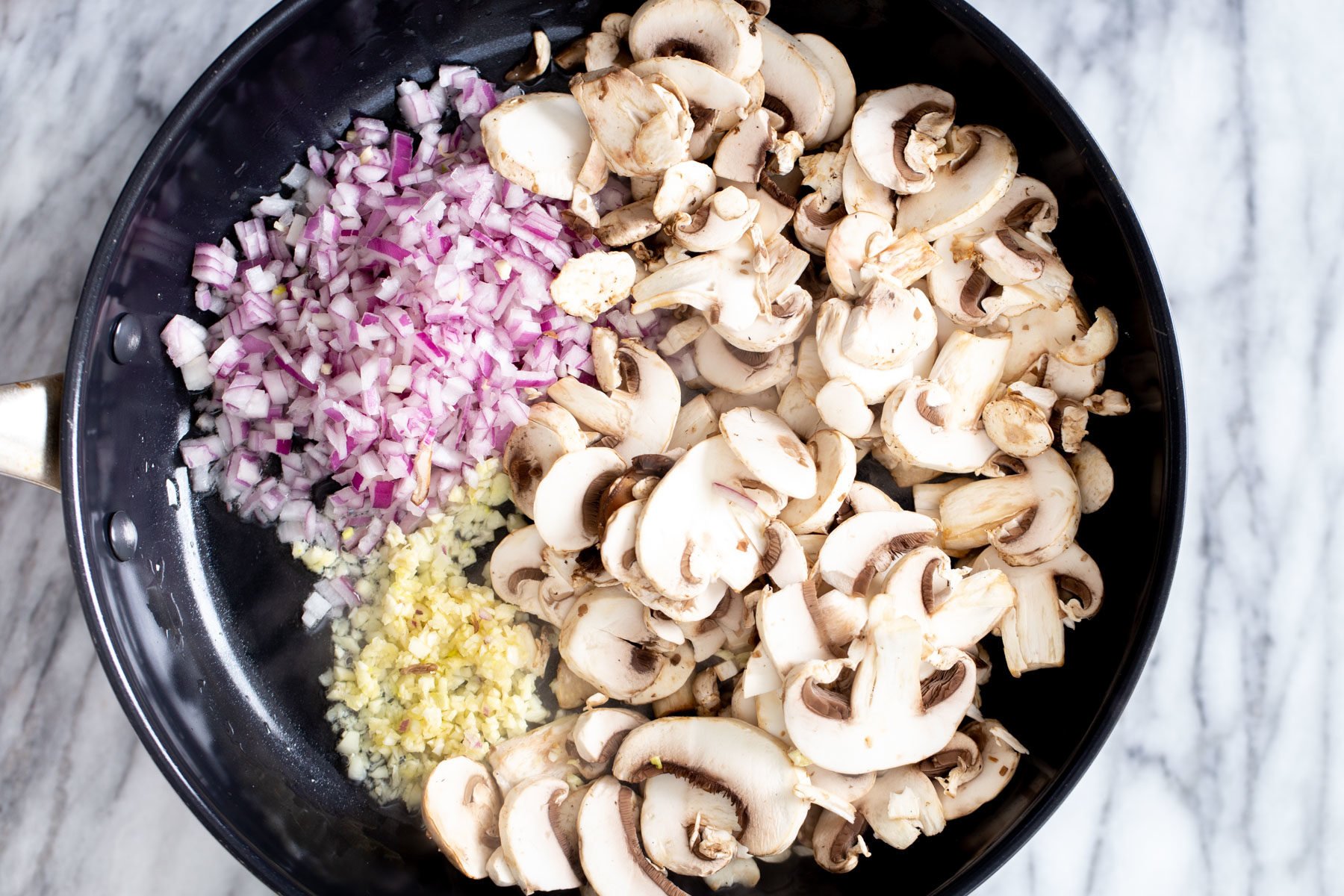 vegan mushroom stroganoff garlic, mushrooms and minced garlic in a frying pan
