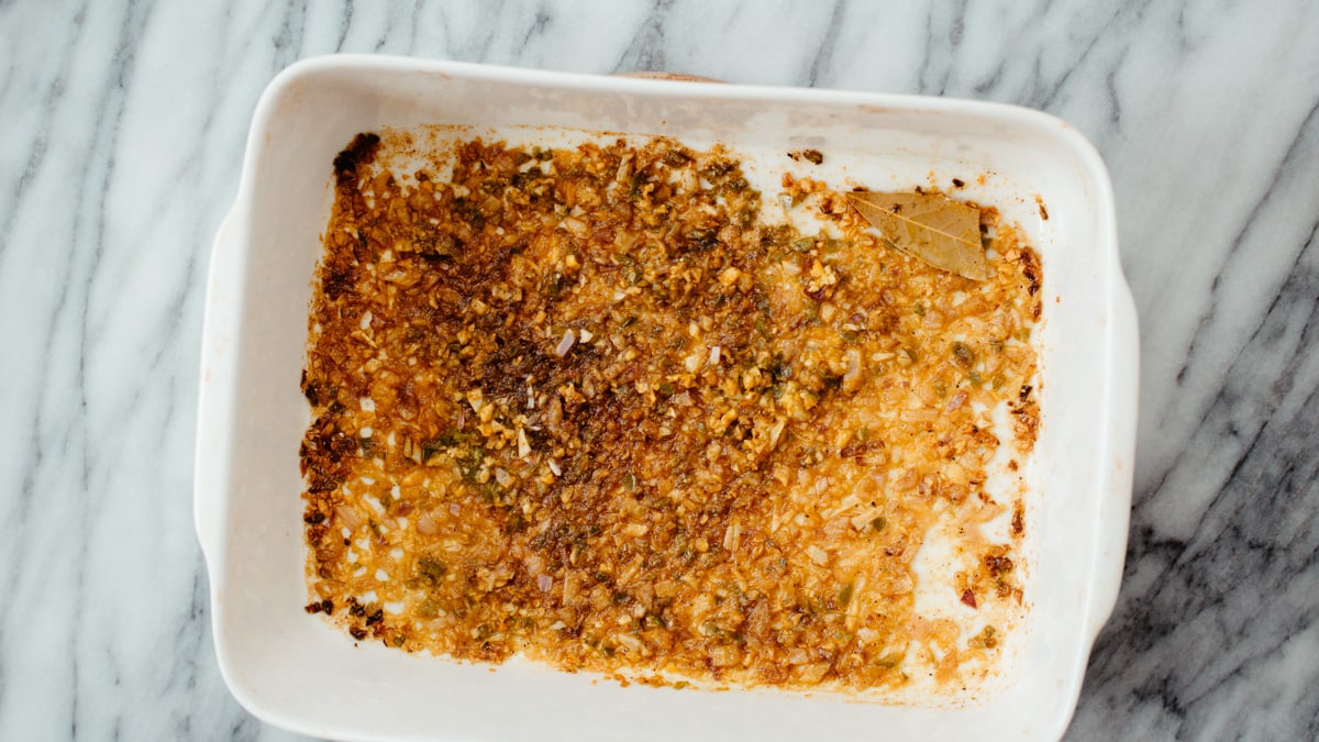 lentil casserole overhead shot of a casserole dish with roasted spices, onions and garlic