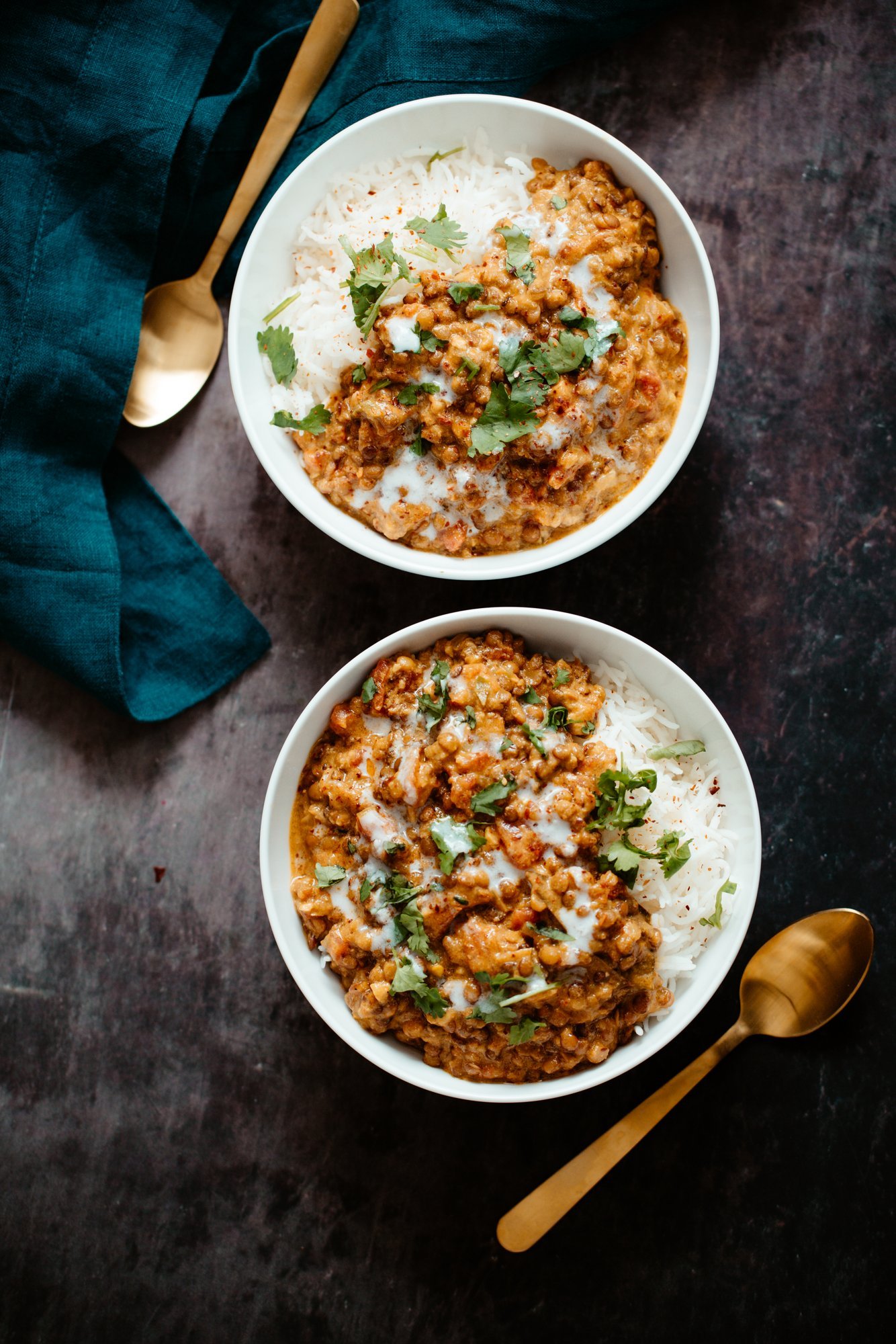 lentil casserole two bowls with rice topped with creamy coconut curry lentil casserole