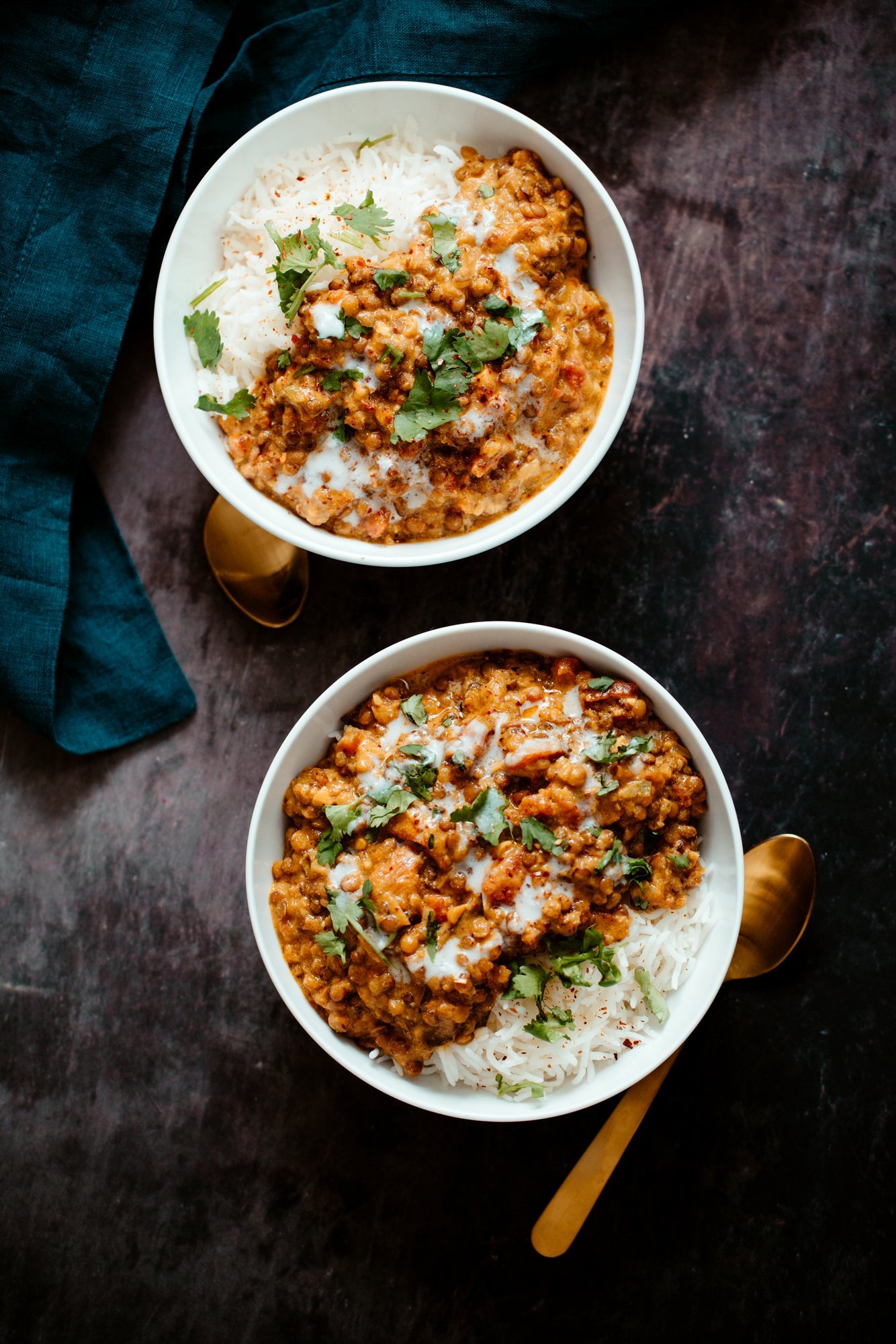 lentil casserole two white bowls filled with rice and vegan Indian Curry Lentil Casserole