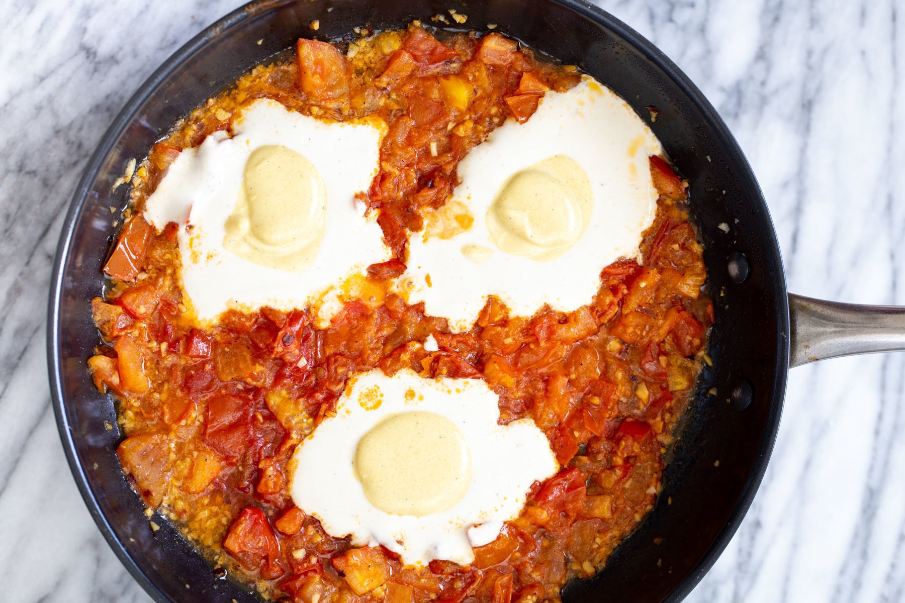 turmeric egg yolks being added on top of tofu egg