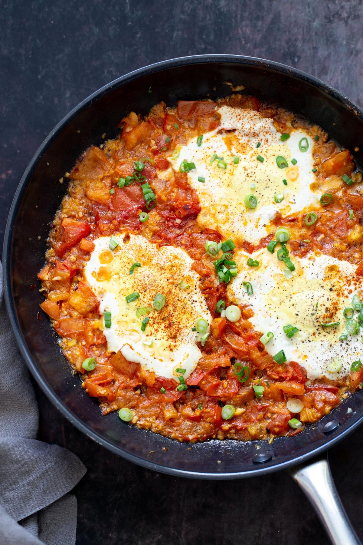 vegan eggs in purgatory with tofu eggs served in a black skillet