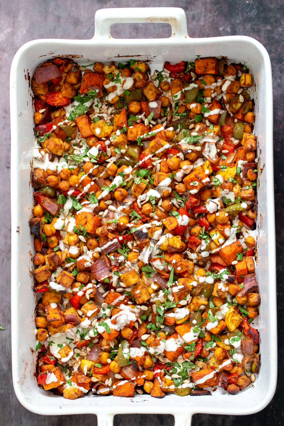 overhead shot of cheeseburger casserole drizzled with vegan mayo made with cashews