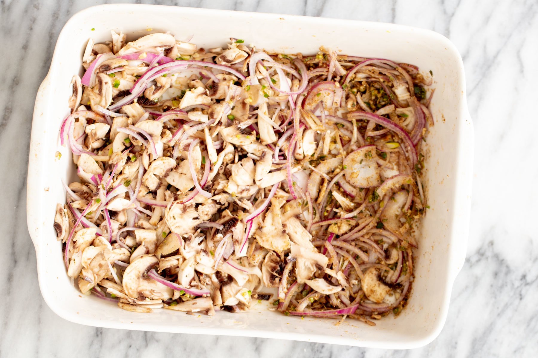onions, sliced mushrooms, chili and garlic in a casserole dish