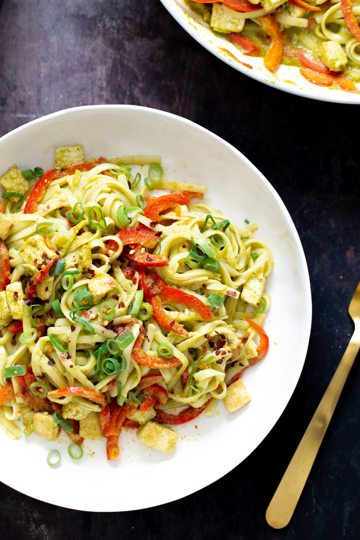 green Thai Curry Noodles a plate of Vegan Thai green curry noodles with a fork on the side