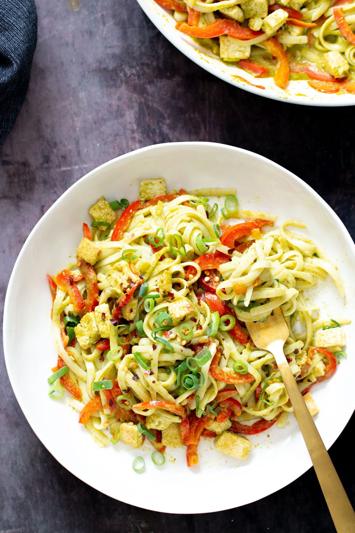 Thai Green Curry Noodles a fork twirling vegan Thai Green Curry Noodles in a noodle bowl