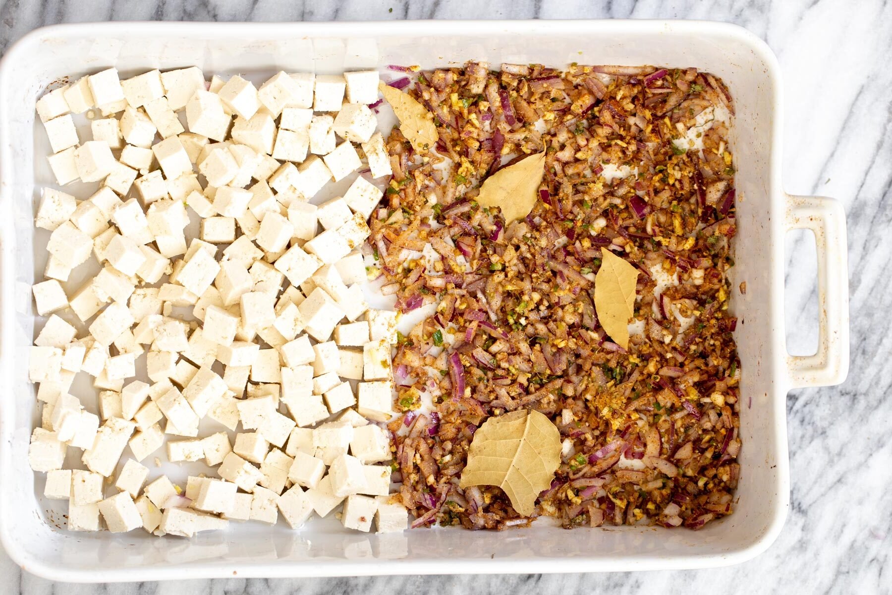 baked tofu cubes, next to minced onion ginger and chili tossed with Indian spices