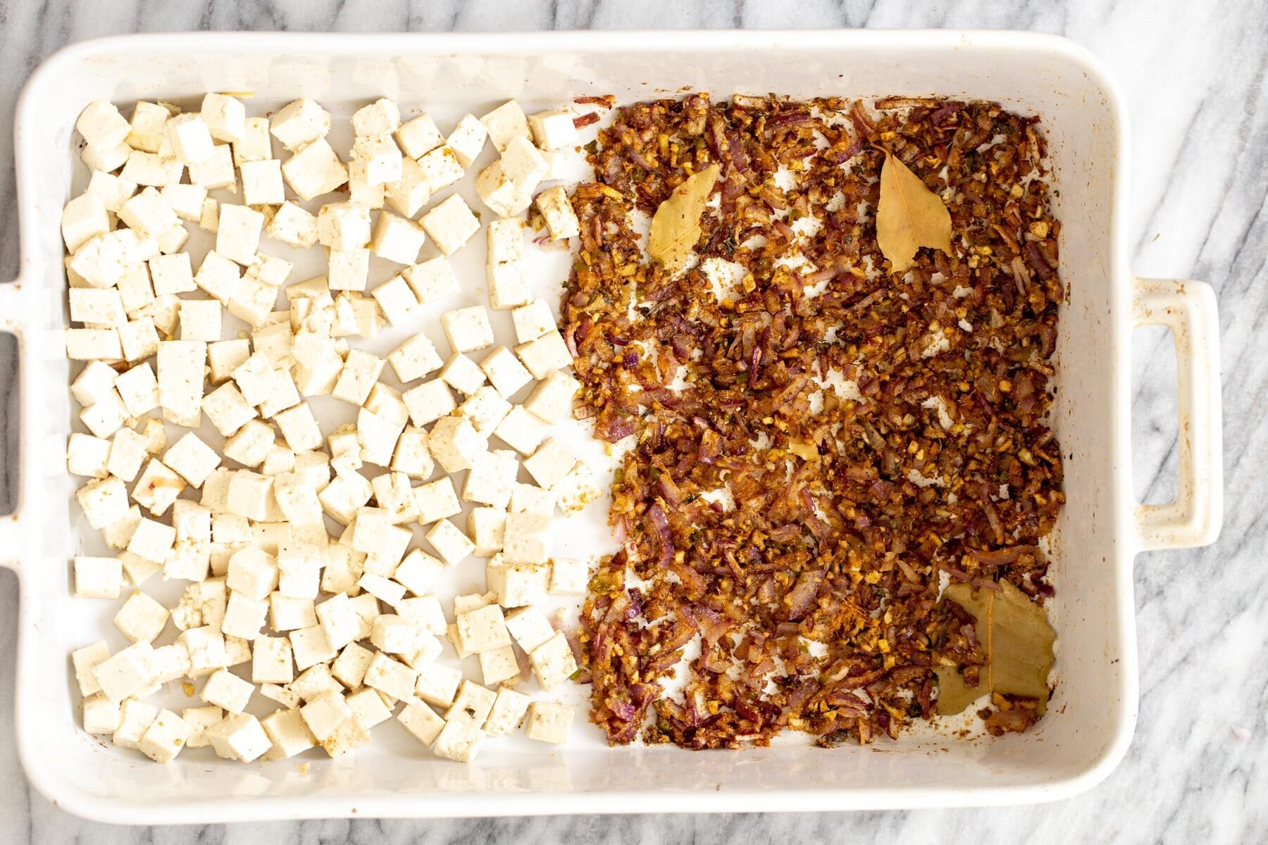baked tofu and baked minced onion garlic ginger in a casserole dish