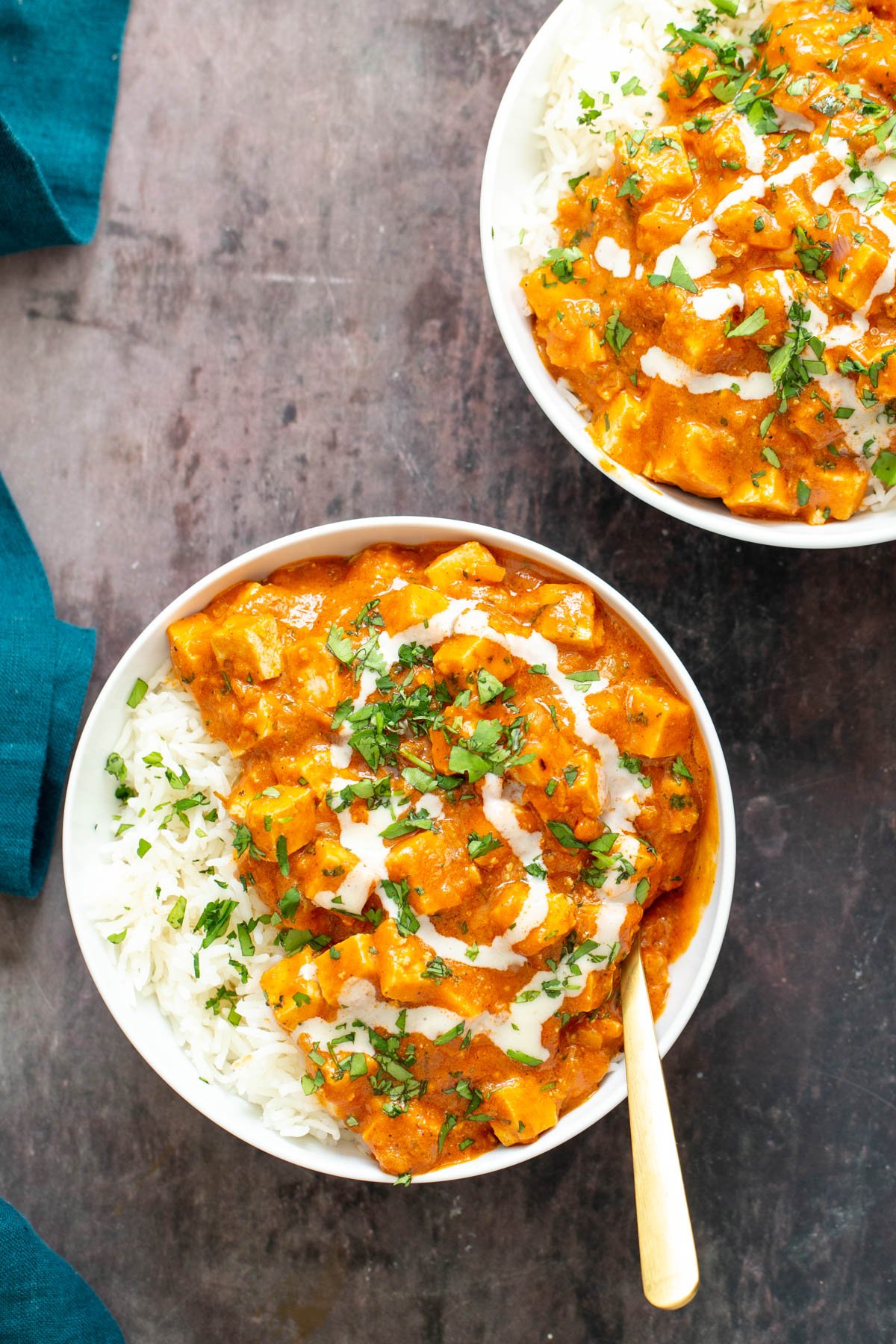 baked tofu curry  two servings of vegan baked tofu curry served with rice and sprinkled with fresh herbs