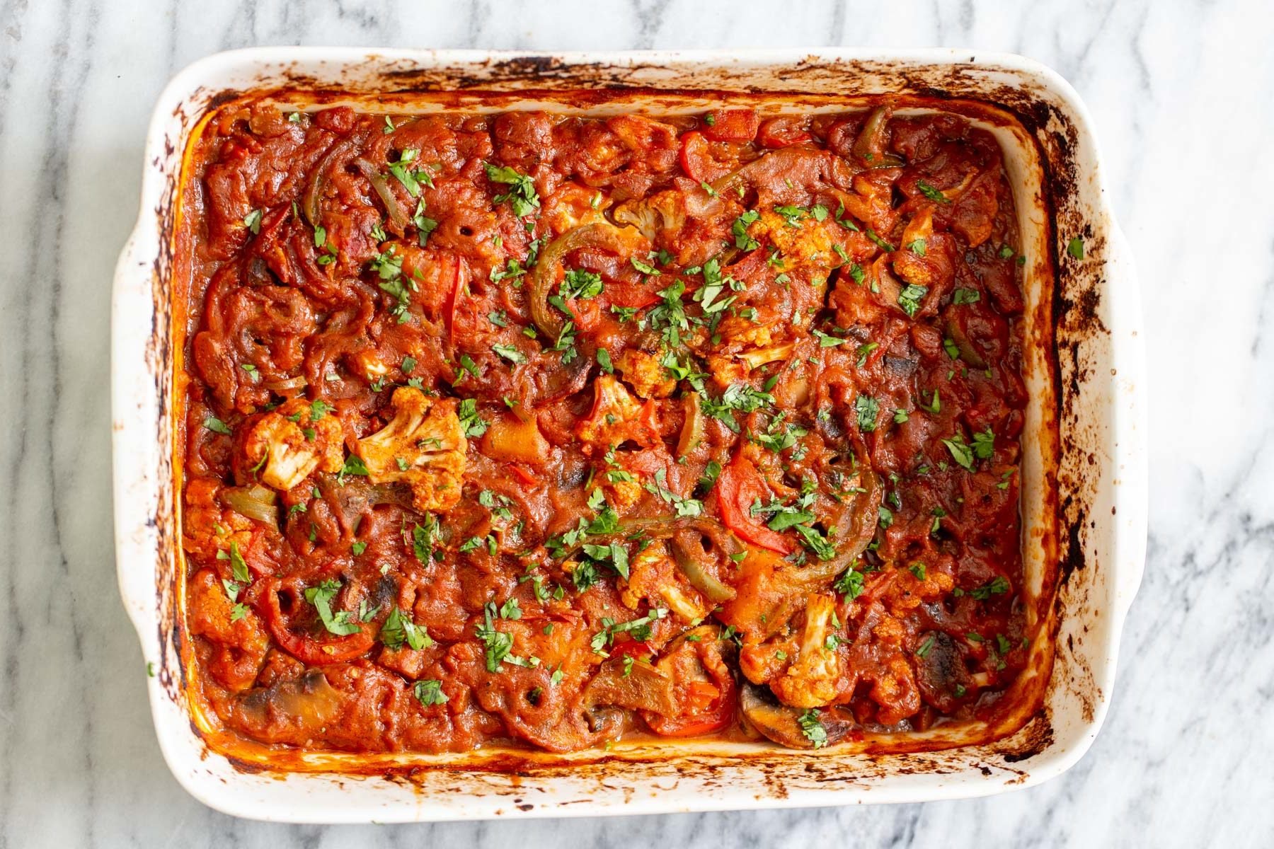 vegetable balti  freshly baked Indian vegetable balti in a white casserole dish