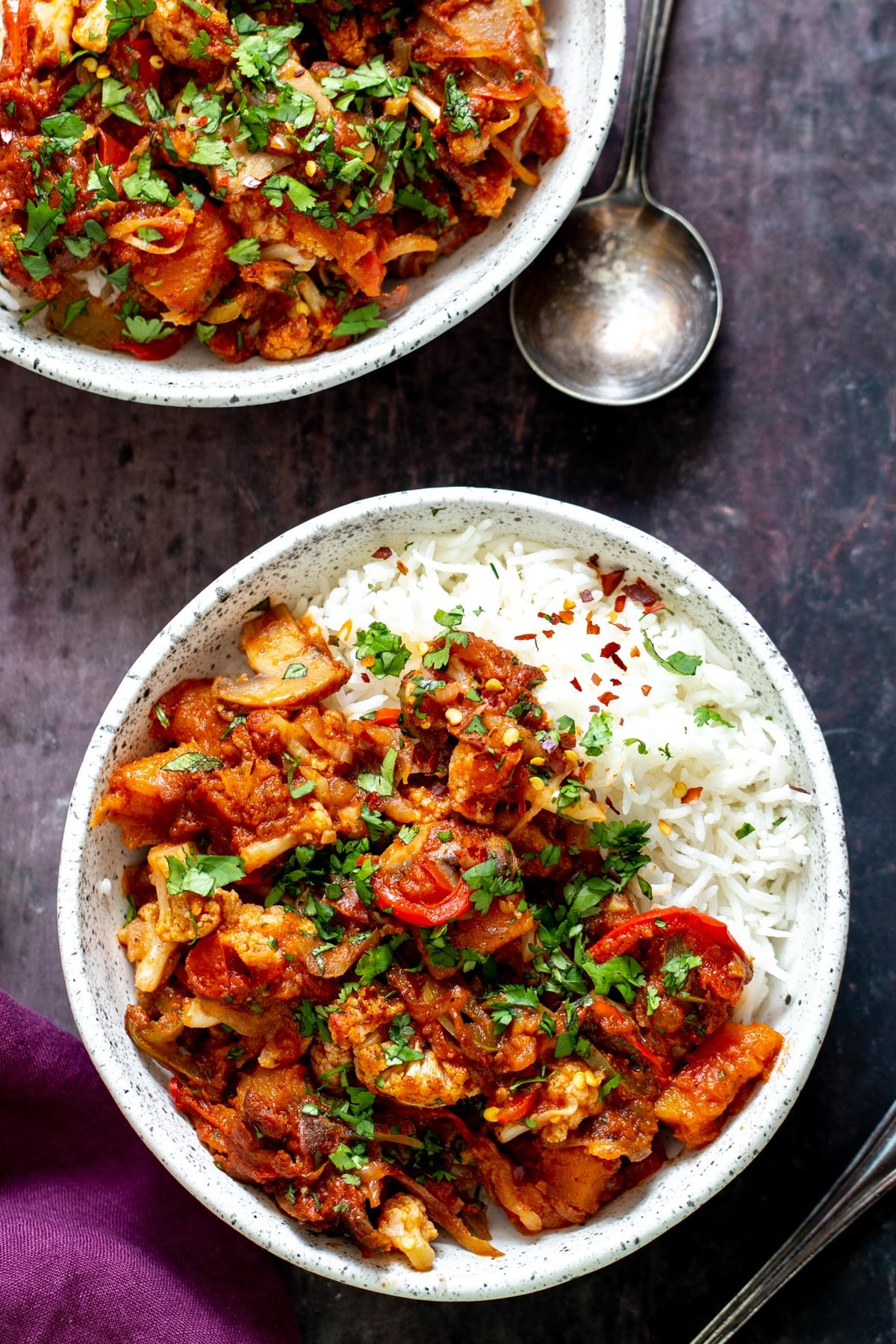 vegetable balti  a bowl of vegetable balti served with rice and sprinkled with fresh parsley