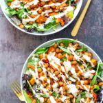 two bowls of sweet potato chickpea salad with tahini dressing