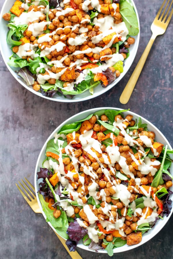 two bowls of sweet potato chickpea salad with tahini dressing