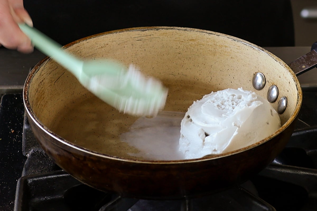 adding coconut cream to the pan