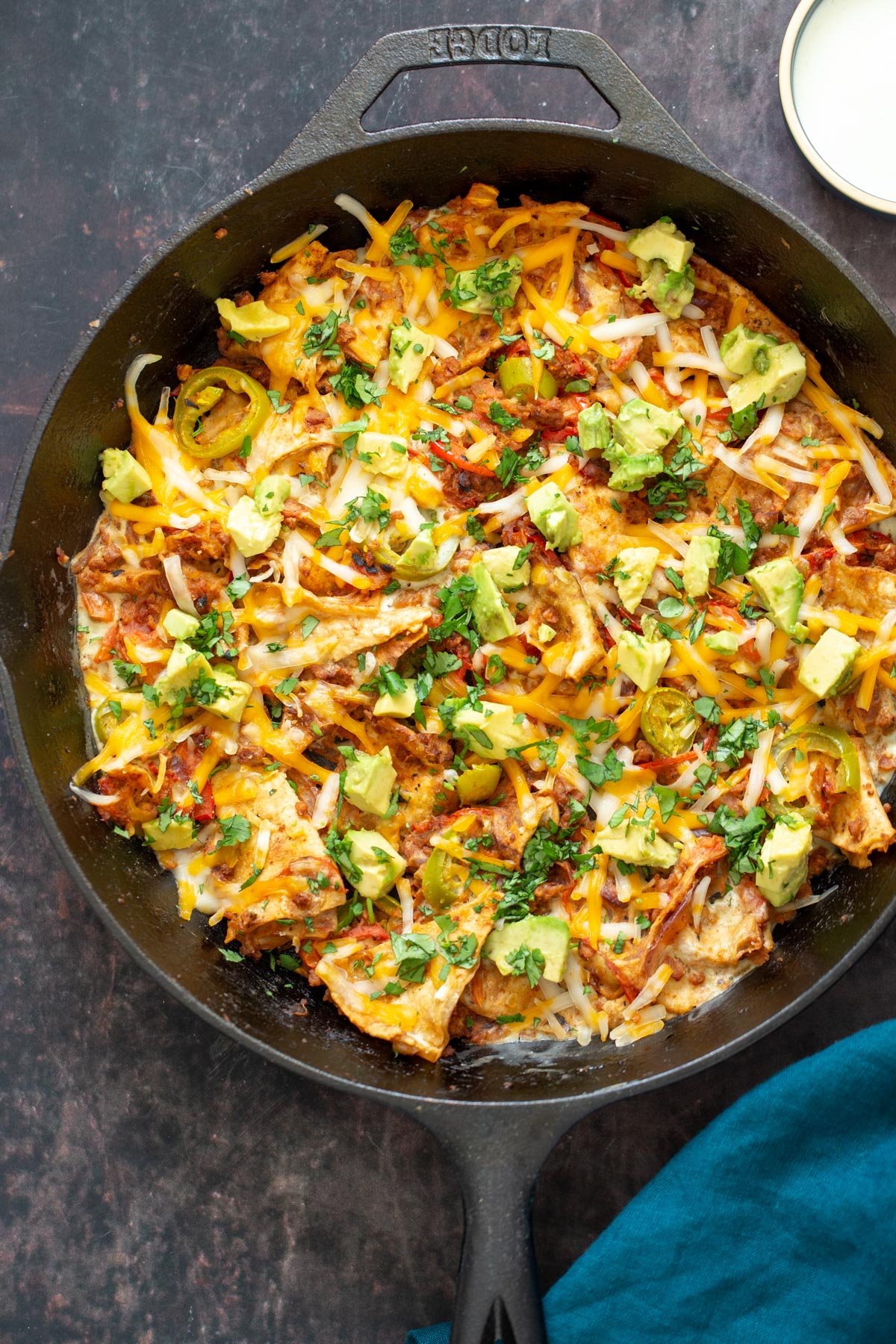 vegan jalapeno popper skillet topped with cilantro and chopped avocado