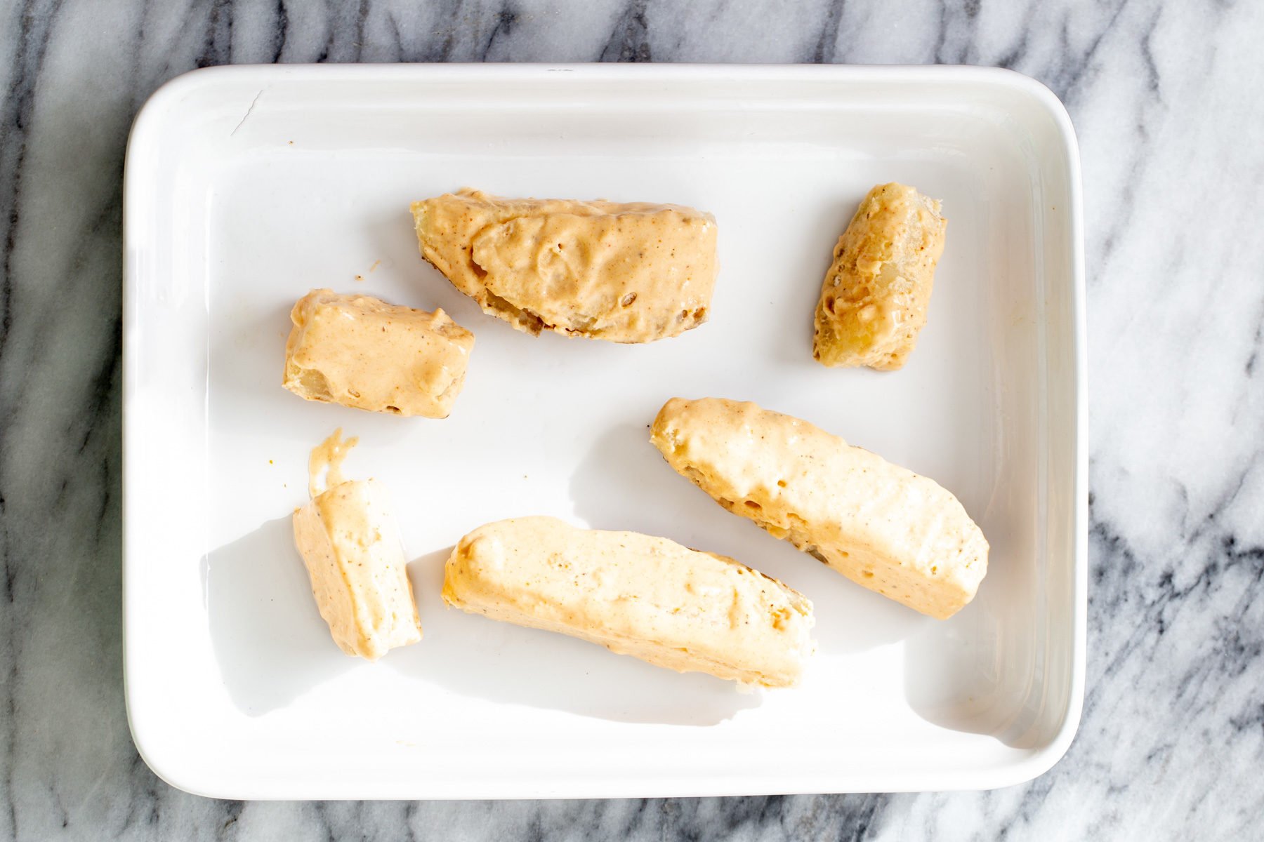 jo jo potatoes breaded potato wedges in a white casserole dish