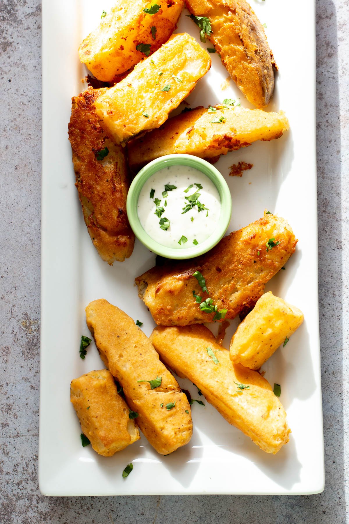 jo jo potatoes vegan homemade baked jo jo potatoes served with a dip on a white platter