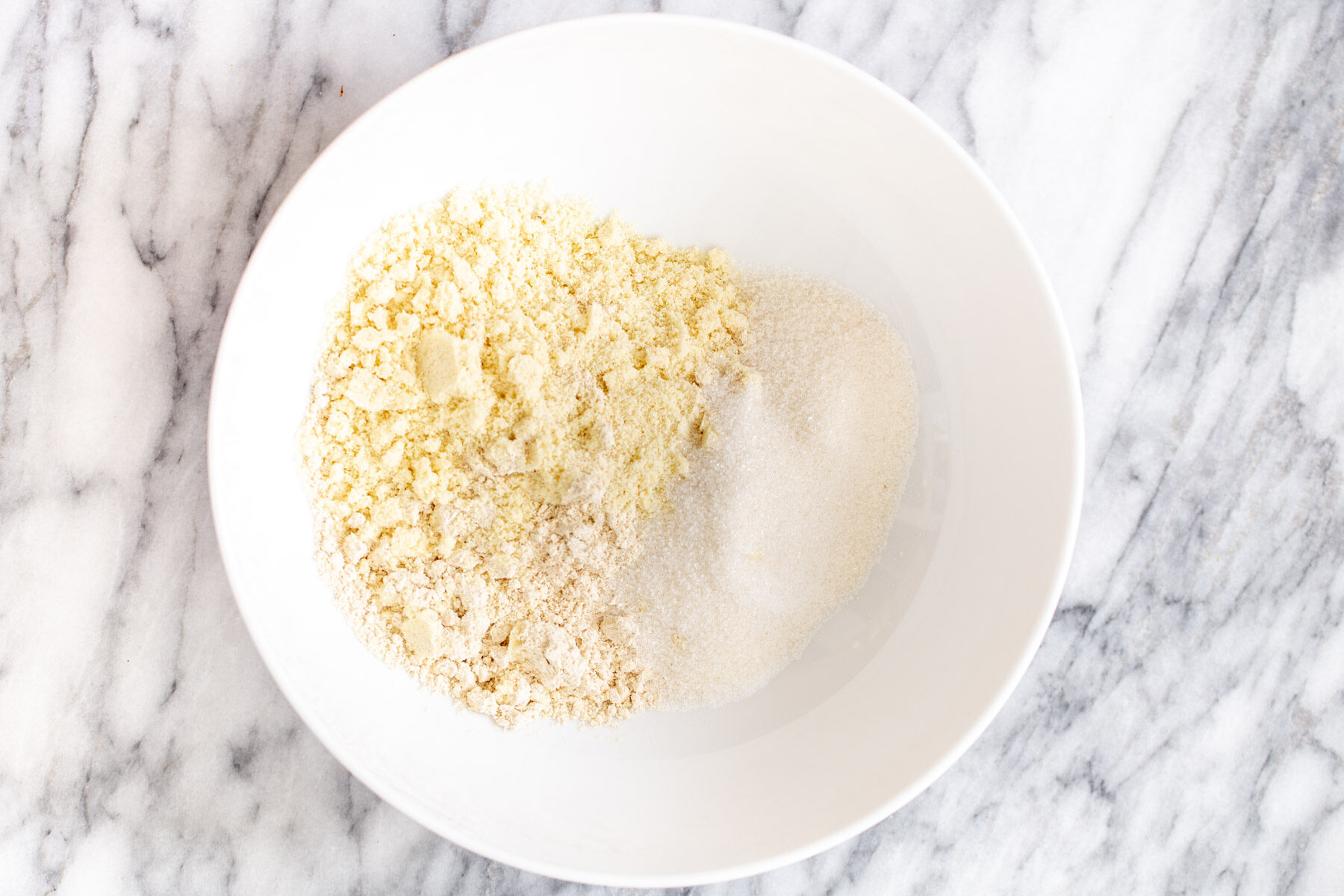 vegan lemon bars  dry ingredients for lemon bars in a small bowl