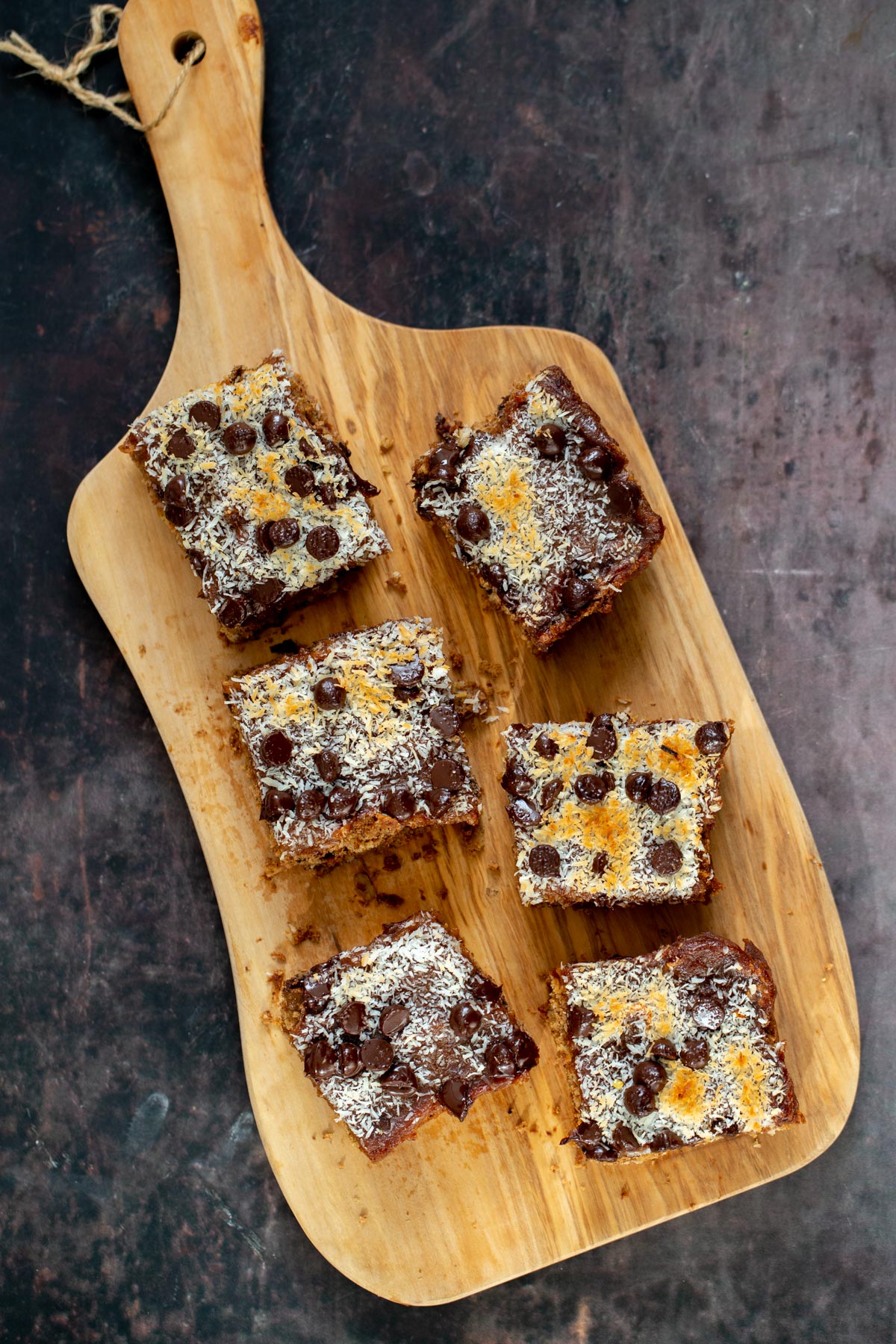 vegan oatmeal date caramel snack bars on a wooden board 
