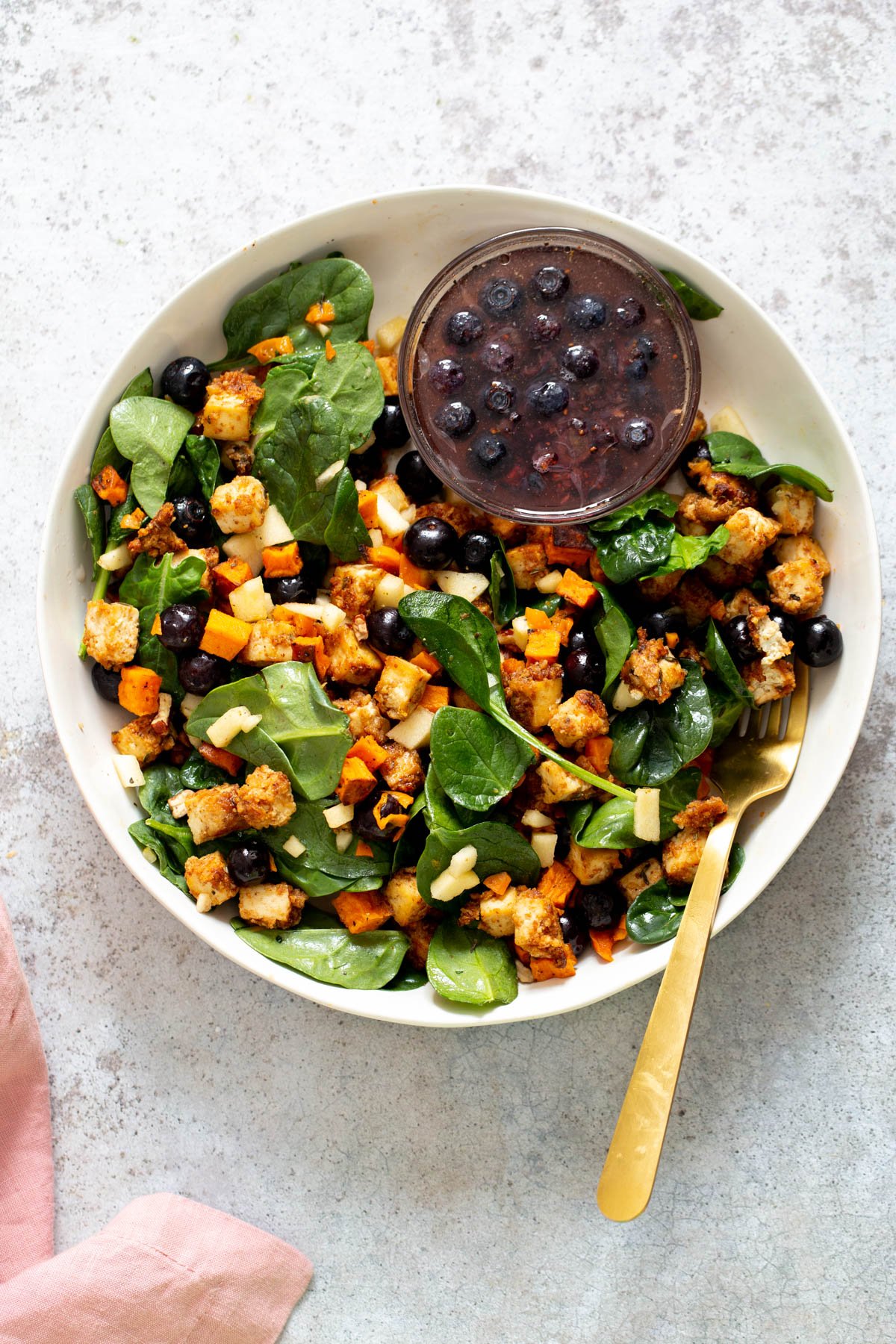 sweet potato tofu bowl overhead shot of spicy maple mustard tofu bowl with sweet potatoes and a side dish of blueberry dressing