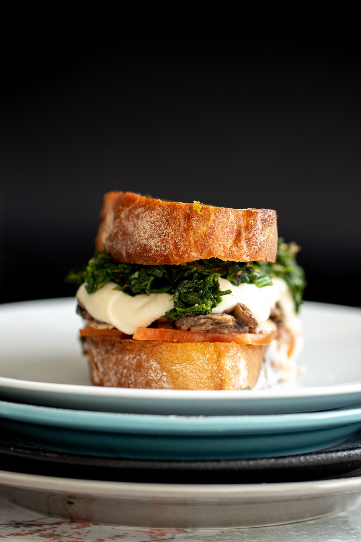 a vegan grilled cheese made with homemade cashew mozzarella , spinach and mushrooms