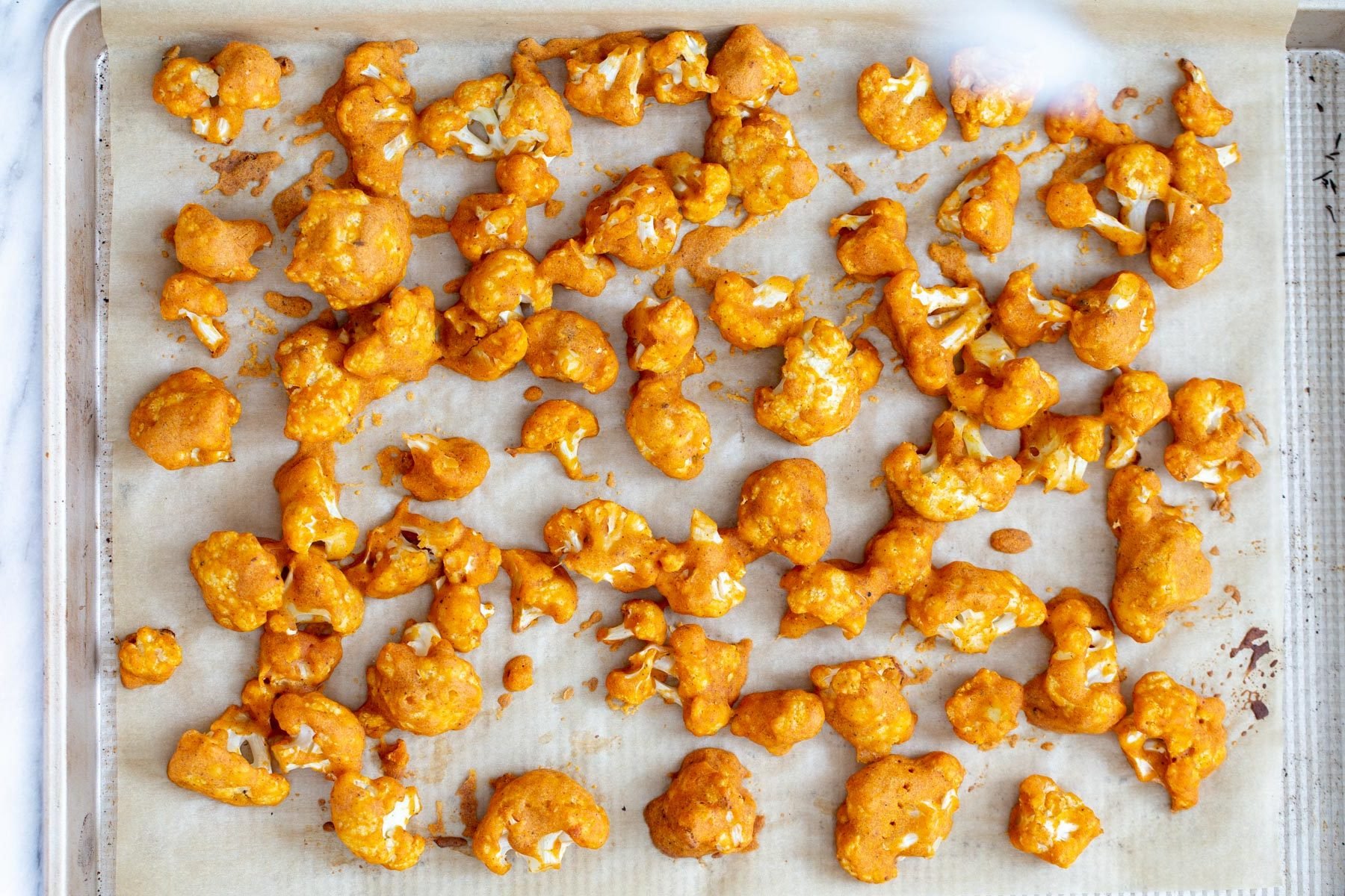 cauliflower wings  baked breaded cauliflower wings on a baking sheet
