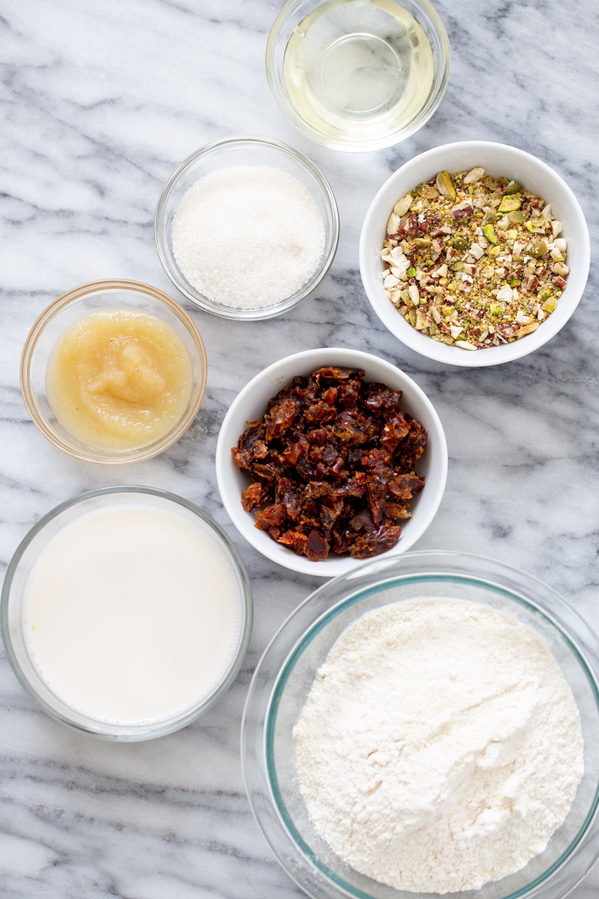 date nut cake  ingredients for vegan date nut cake on a marble countertop