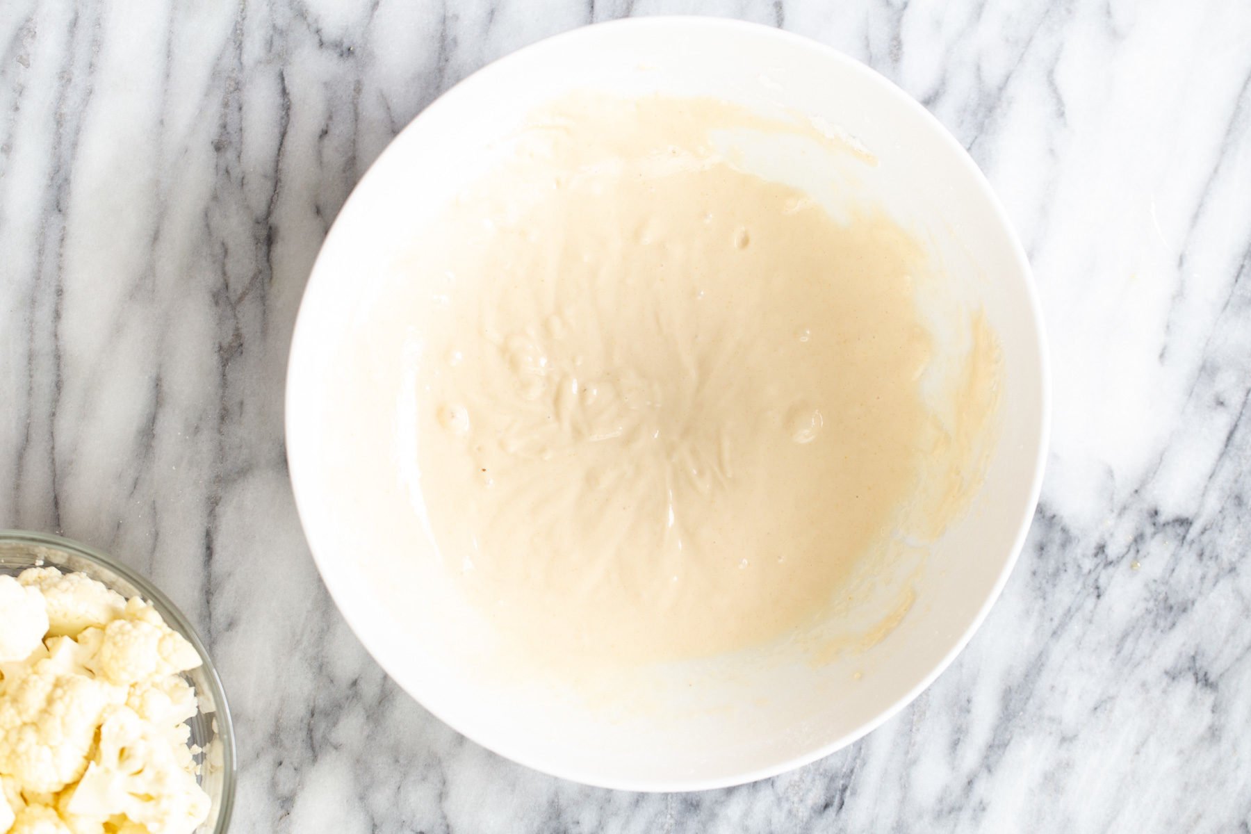 cauliflower manchurian  batter for cauliflower manchurian in a small white bowl
