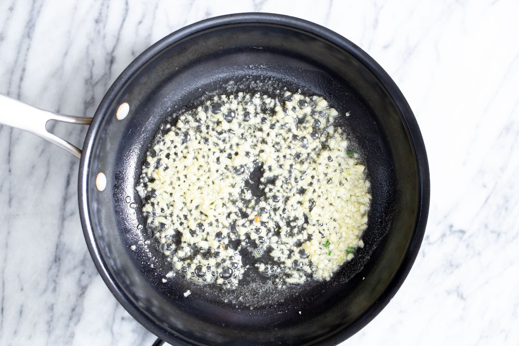 garlic being fried in a pan