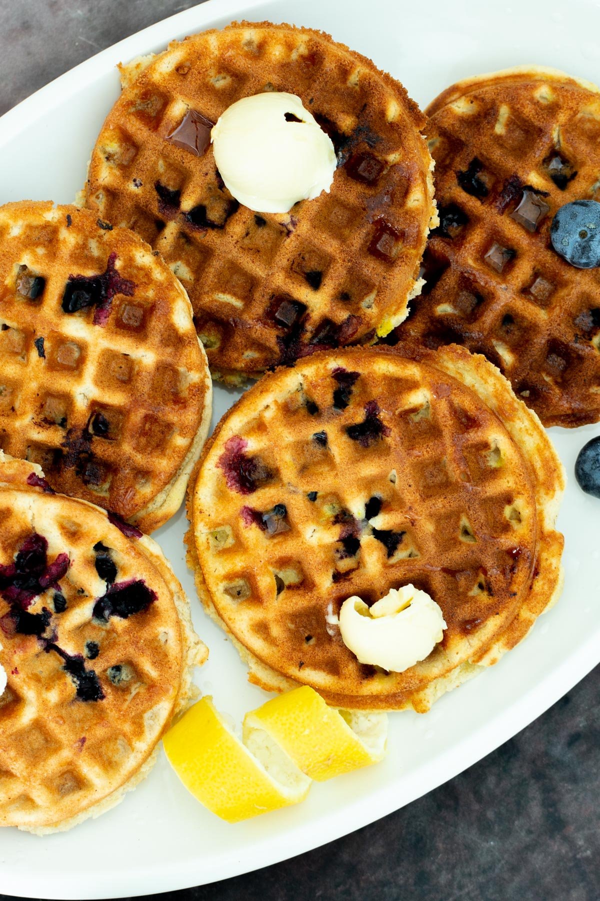 lemon blueberry muffins vegan glutenfree Lemon Blueberry Waffles on a platter served with dollops of butter