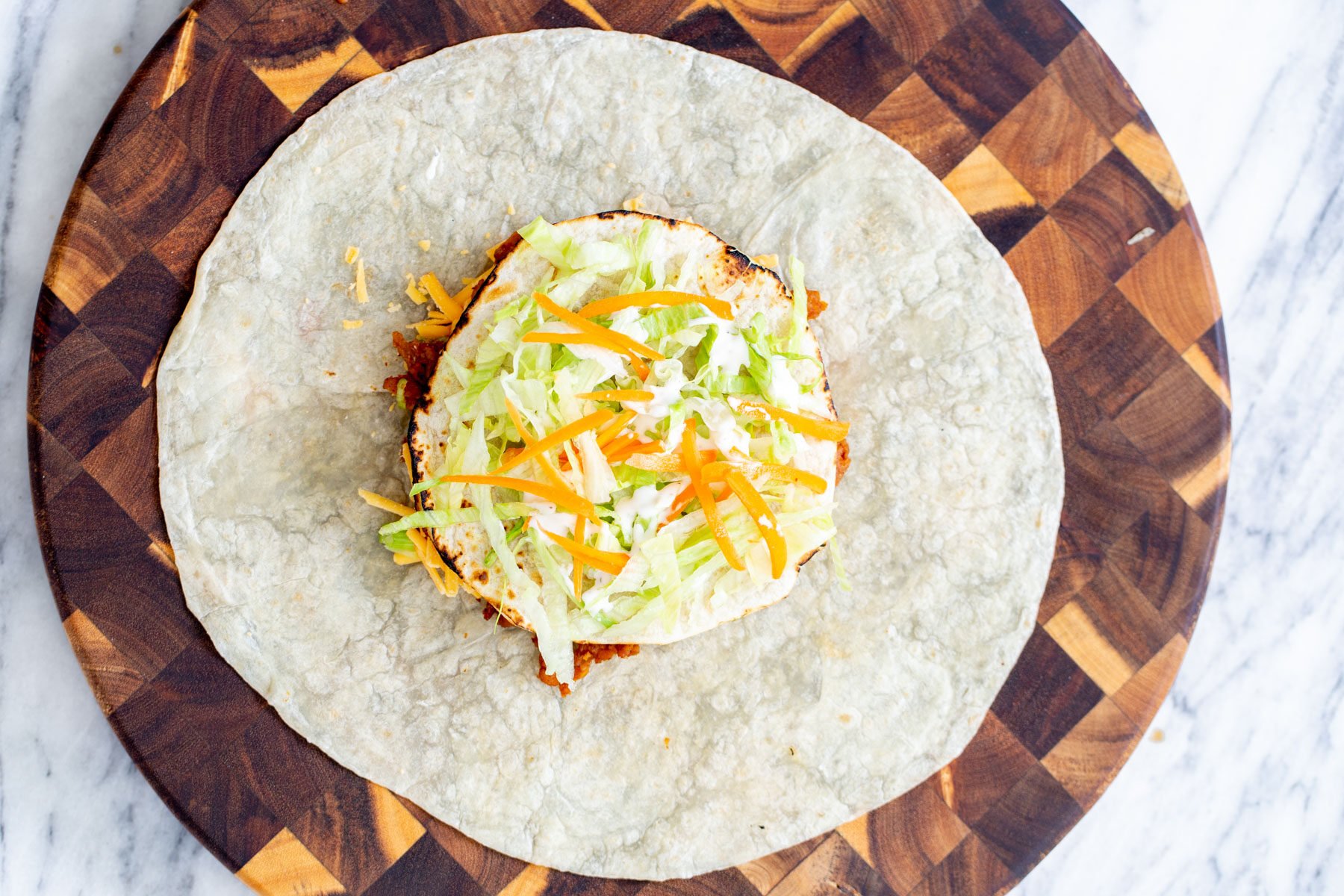 vegan crunchwrap  vegan crunchwrap with toppings ready to be folded and toasted